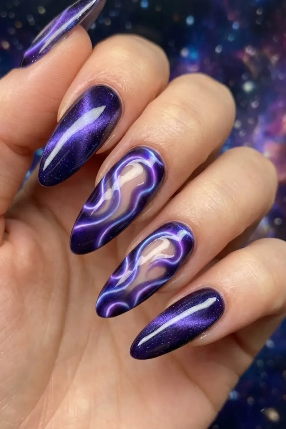 Blue and purple galactic aura cat eye nails with abstract swirl design