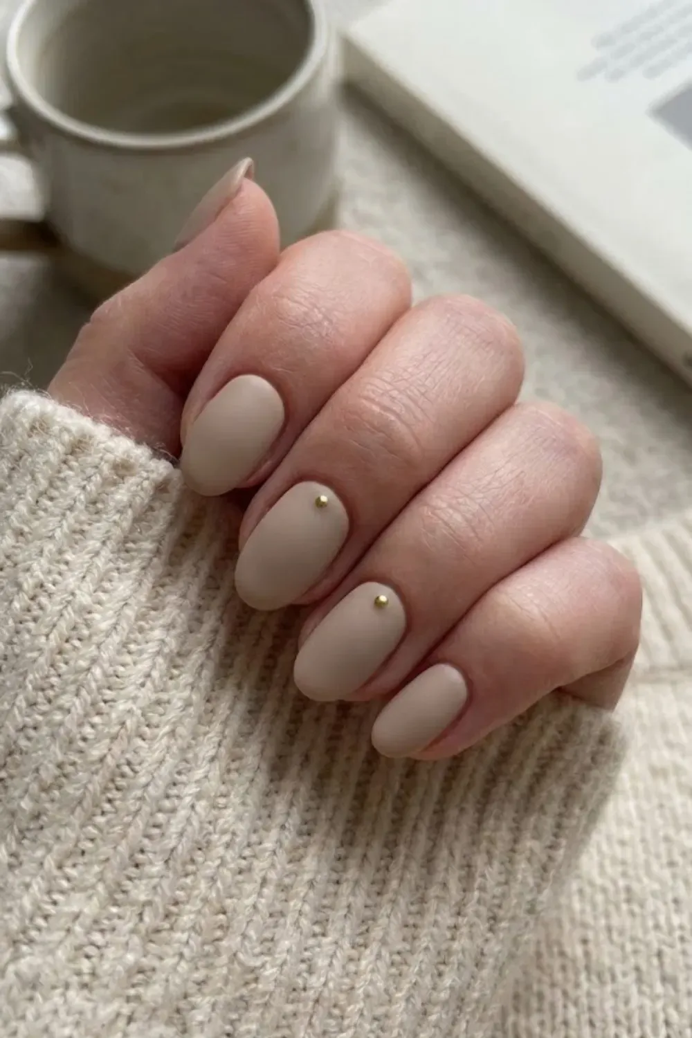 Matte Beige Gold Studs – Matte finished beige oval nails accented with tiny minimal gold studs at the base.