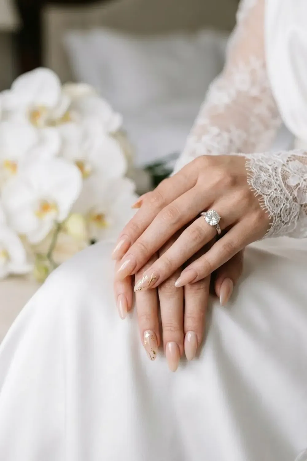 Scattered Gold Foil Flake - Hand on white sleeve; gold leaf flakes scattered on nude.