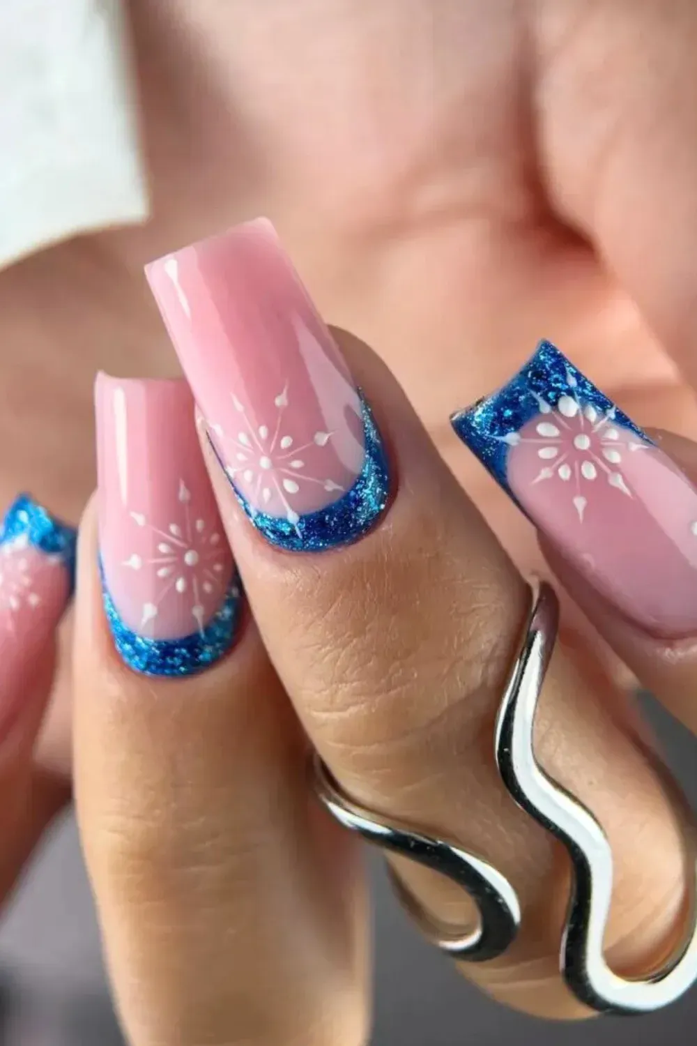 Frozen Blue French Tips - Pink square nails with sparkling blue french tips and white snowflake details.