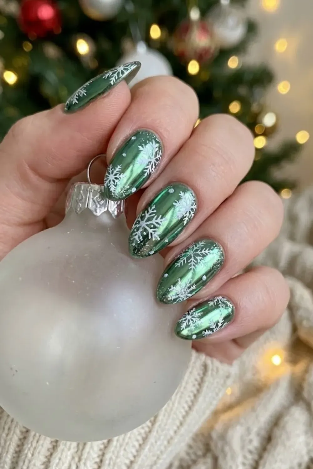 Chrome Snowflake Nails – metallic green chrome nails with white snowflake nail art