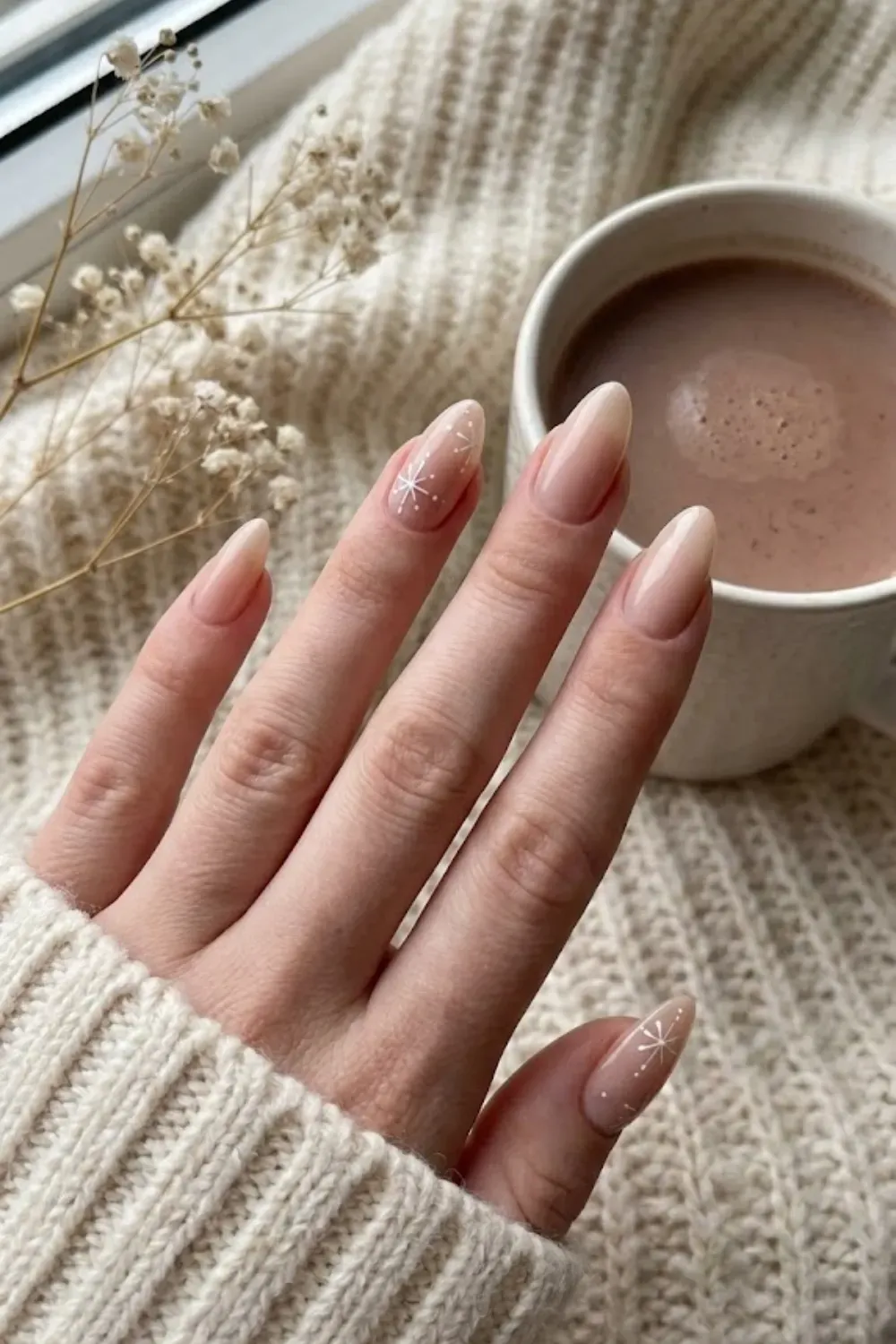 Minimalist Nude Nails with White Snowflakes - Sheer nude almond nails with minimalist white fine-line snowflakes and dots.
