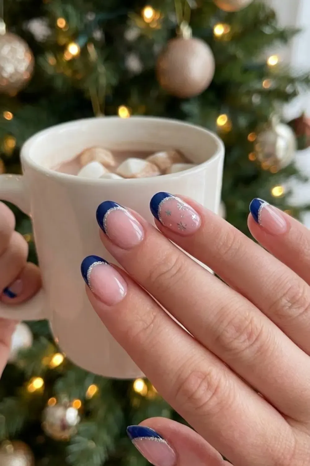 Navy and Silver Glitter French - oval nude nails with dark navy french tips lined with silver glitter