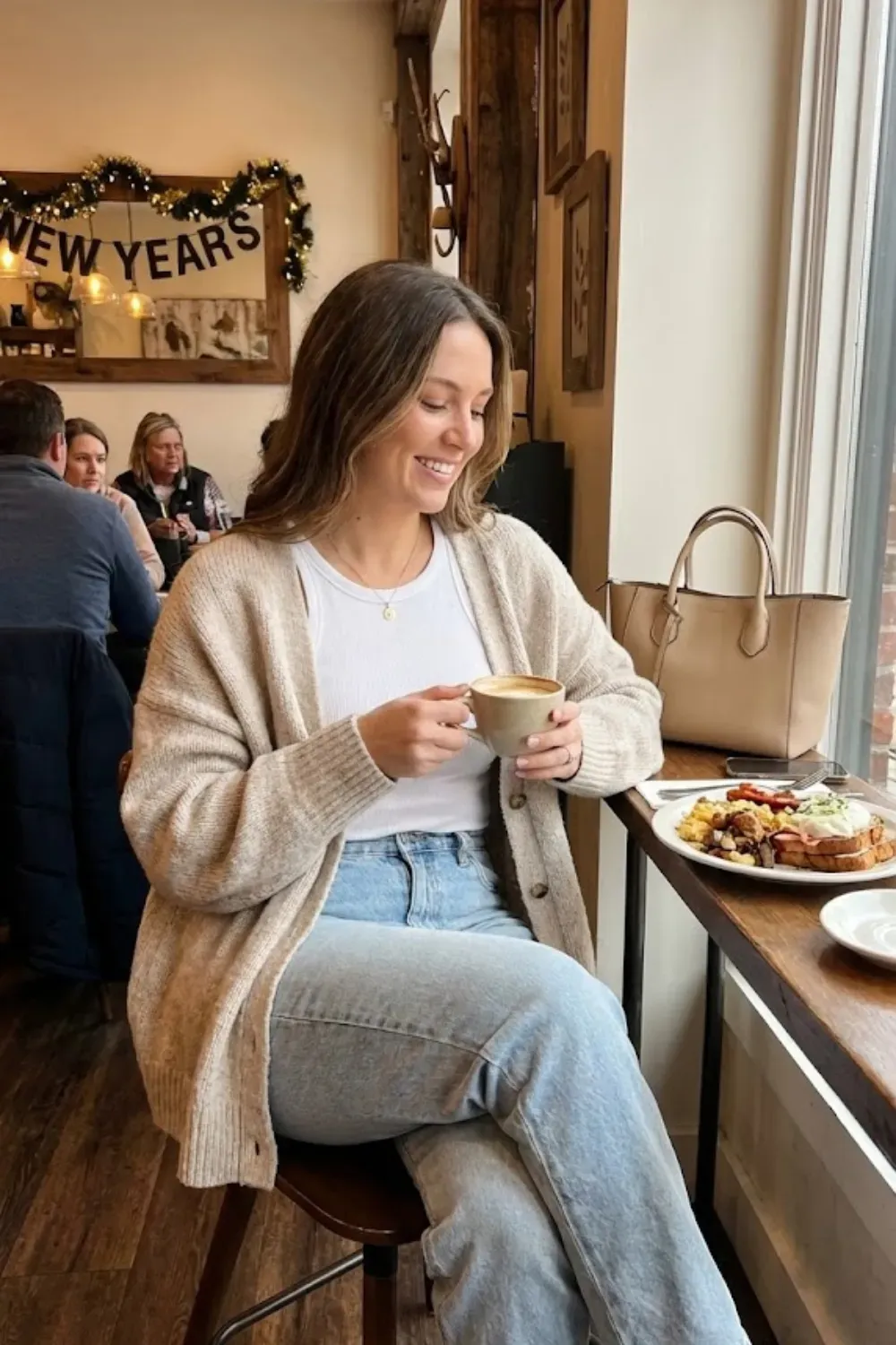 Casual Brunch Cardigan & Jeans – Relaxed brunch outfit with a beige cardigan over a white tank top and light wash jeans.