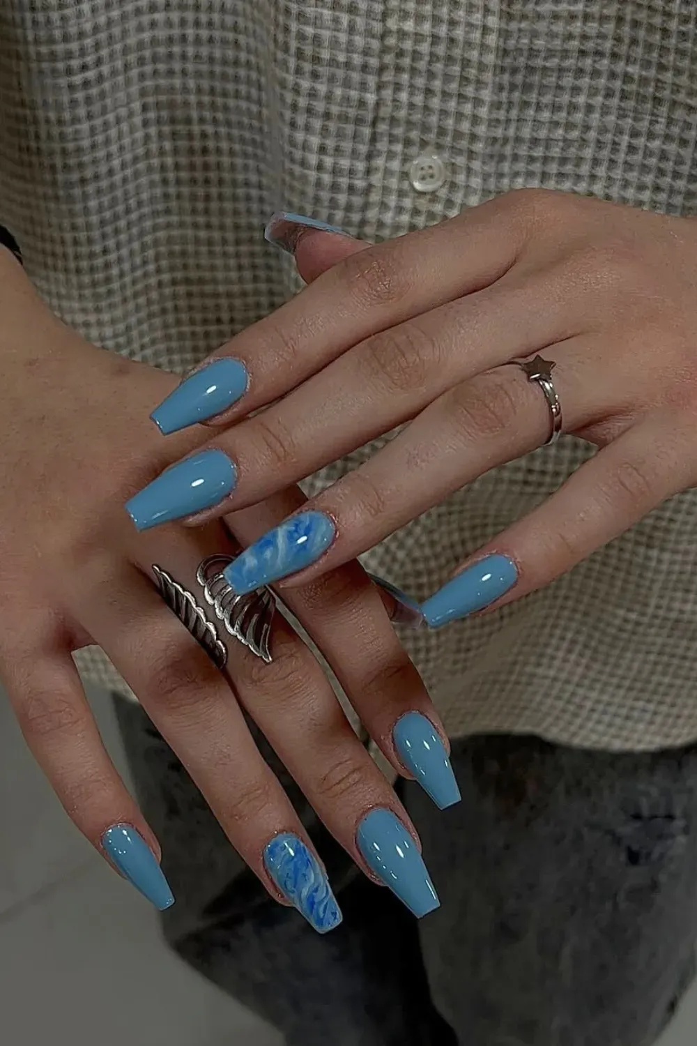 Dusty Blue Coffin Nails with Marble Accent – Long coffin nails featuring a muted dusty blue polish and a statement marble accent nail with white and blue swirling smoke effects.
