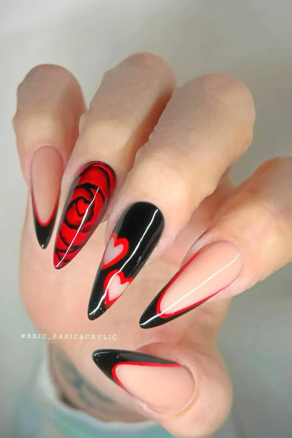 Black and Red Abstract Rose and Heart Art – Stiletto nails featuring dramatic black and red rose art and negative space hearts.