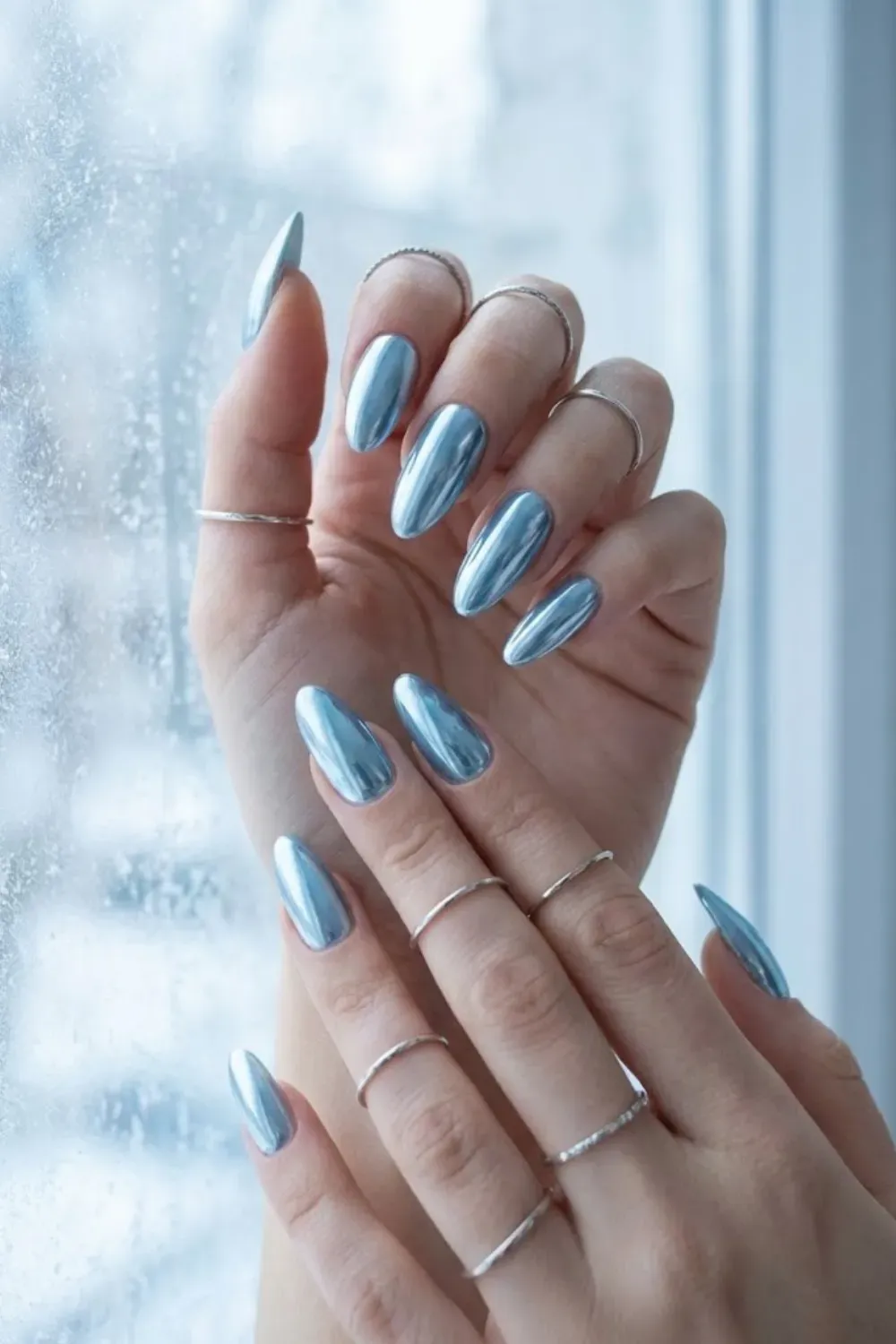 Full Coverage Icy Blue Chrome Nails – Stunning full-coverage icy blue chrome almond nails with a mirror-like finish, a top Pinterest trend for winter.