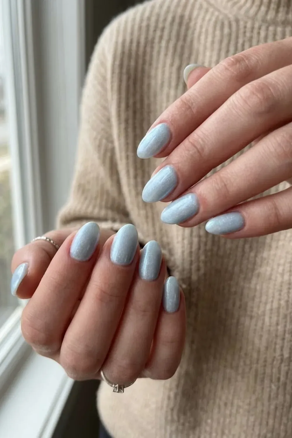 Shimmery Frosty Blue Oval Nails – Oval nails with a frosted shimmery light blue finish, resembling glistening snow, ideal for a subtle winter glow