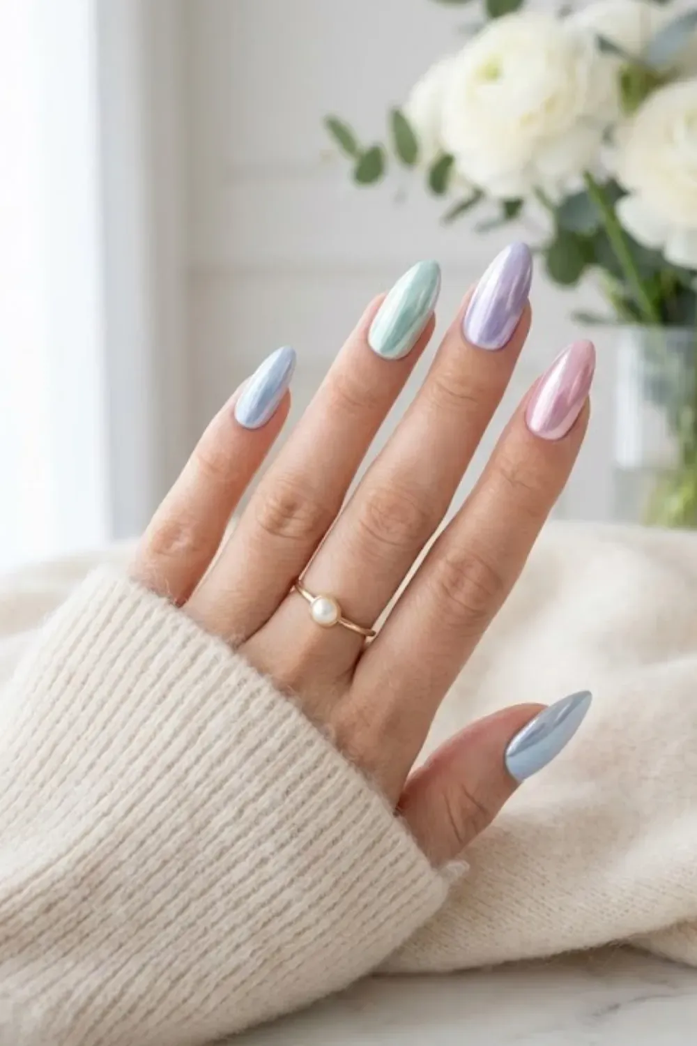 Multi-colored pastel nails with a metallic chrome finish, trendy and modern.