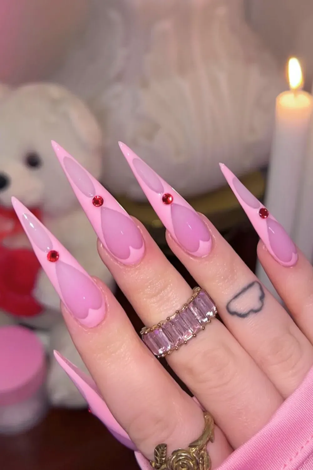 Matte Pink Stiletto Nails with 3D Heart Gems – Long matte pink stiletto nails decorated with 3D heart gems and red crystals.