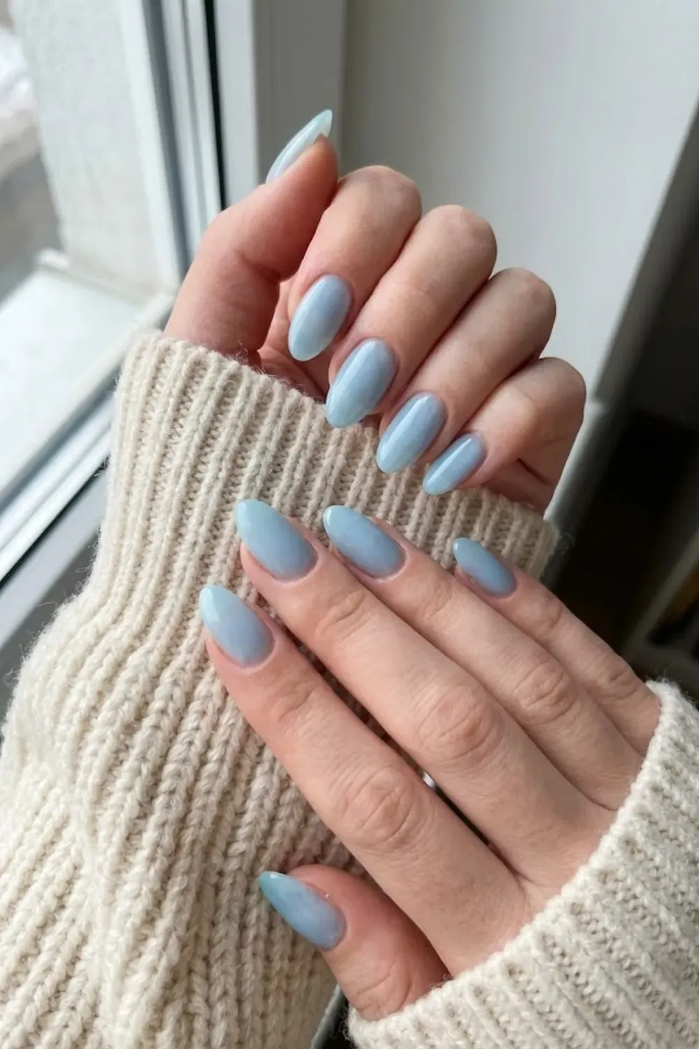 .Glossy Milky Blue Almond Nails – Solid glossy milky light blue almond nails, a simple and elegant "clean girl" winter manicure.