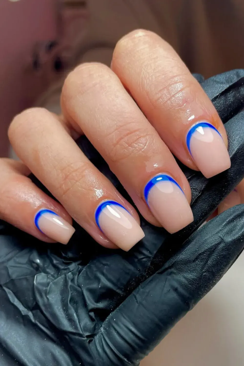 Electric Blue Reverse French Cuff – Short square nails with a natural nude base highlighted by a vibrant electric blue reverse French line at the cuticle.