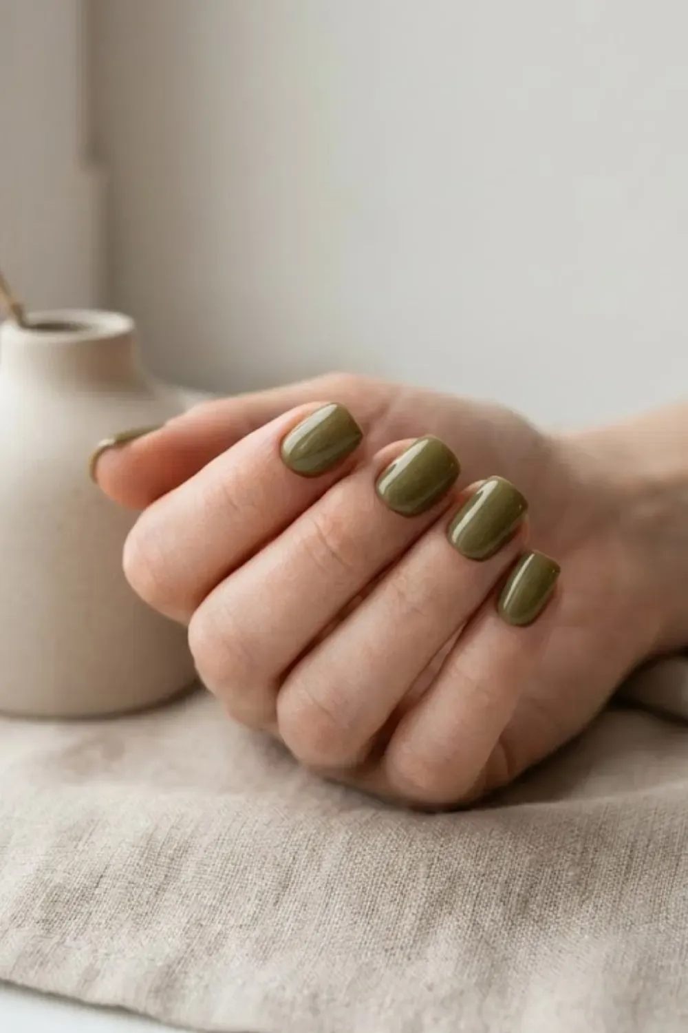 Short square nails in a deep earthy olive green.