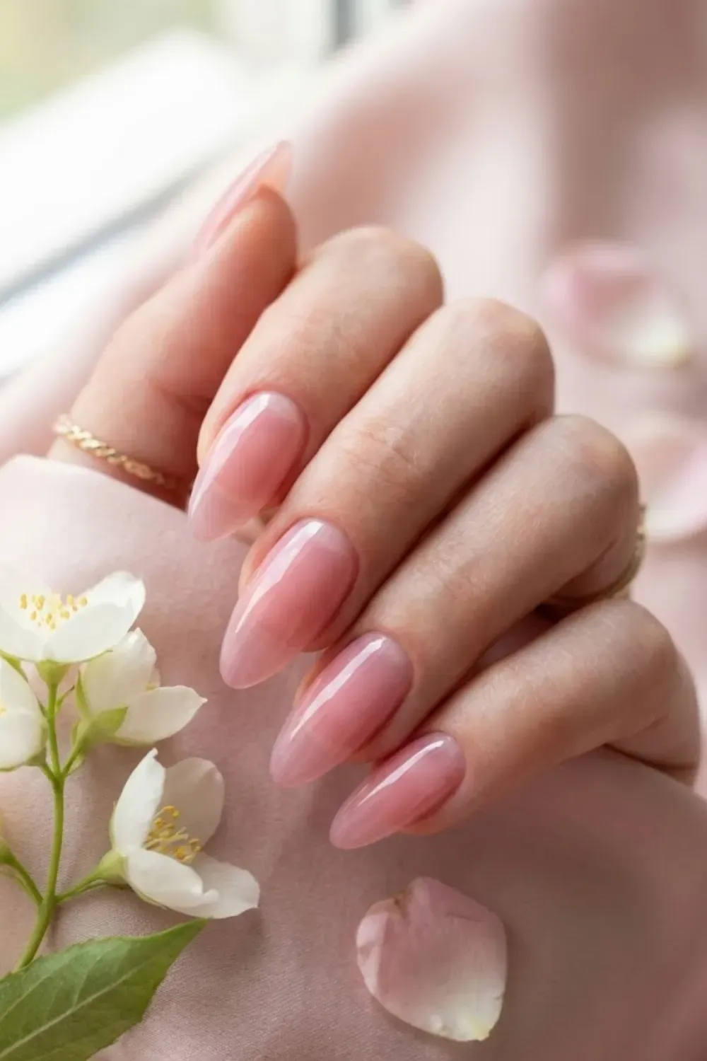 Translucent pink nails resembling rose quartz crystal.