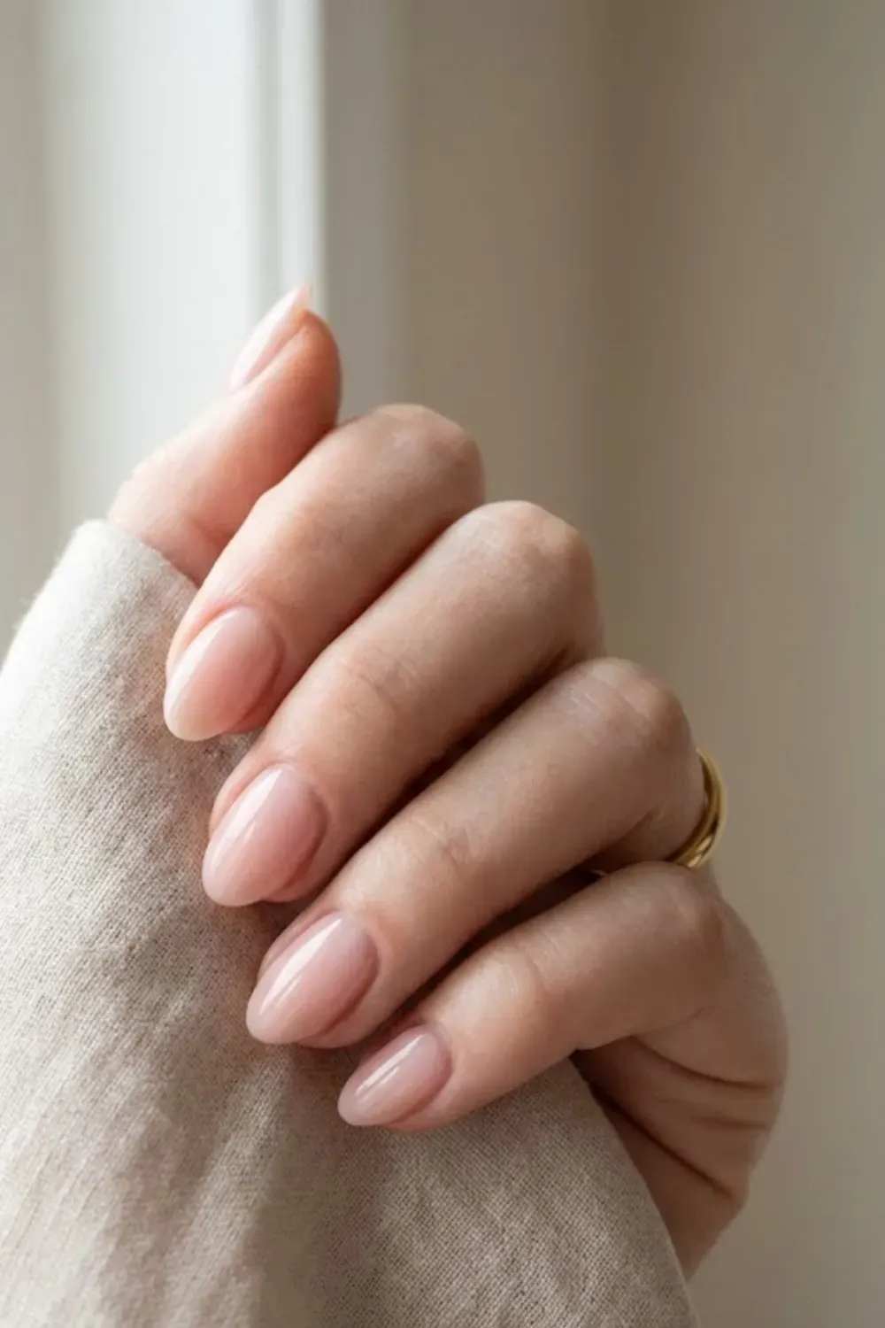 Oval nails with a sheer pink "lipgloss" finish, looking natural and healthy.