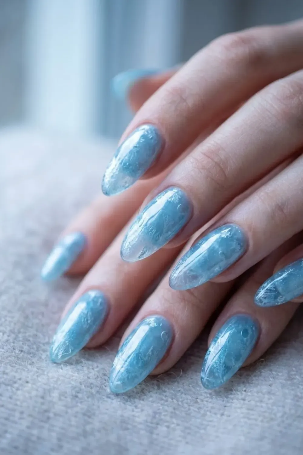 Frozen Texture Jelly Blue Almond Nails – Textured "frozen" effect nails in a jelly blue shade, resembling ice crystals on almond-shaped nails.