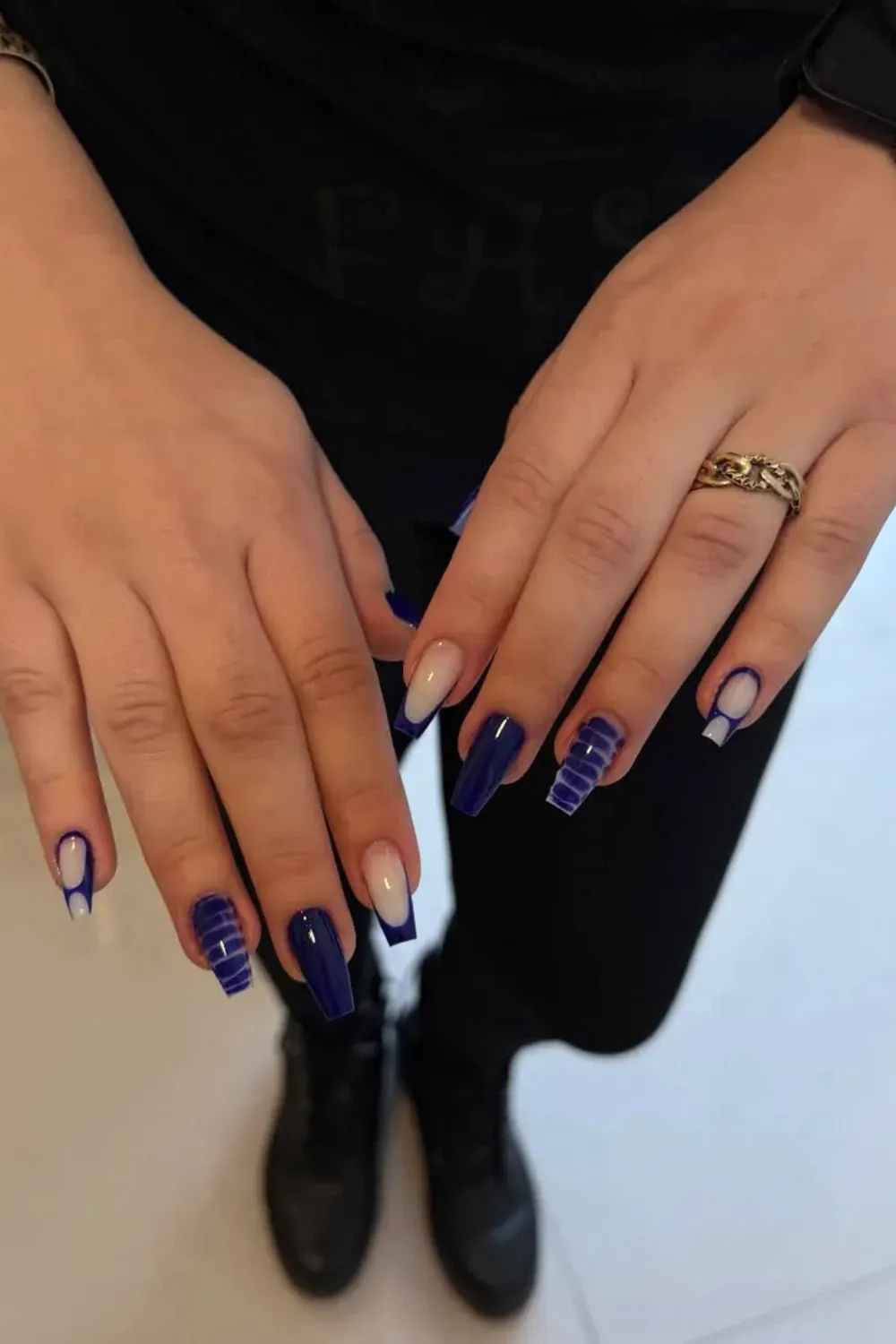 Navy Blue Geometric Negative Space Nails – Long coffin nails in deep navy blue featuring a mix of solid glossy finish and geometric windowpane grid art.