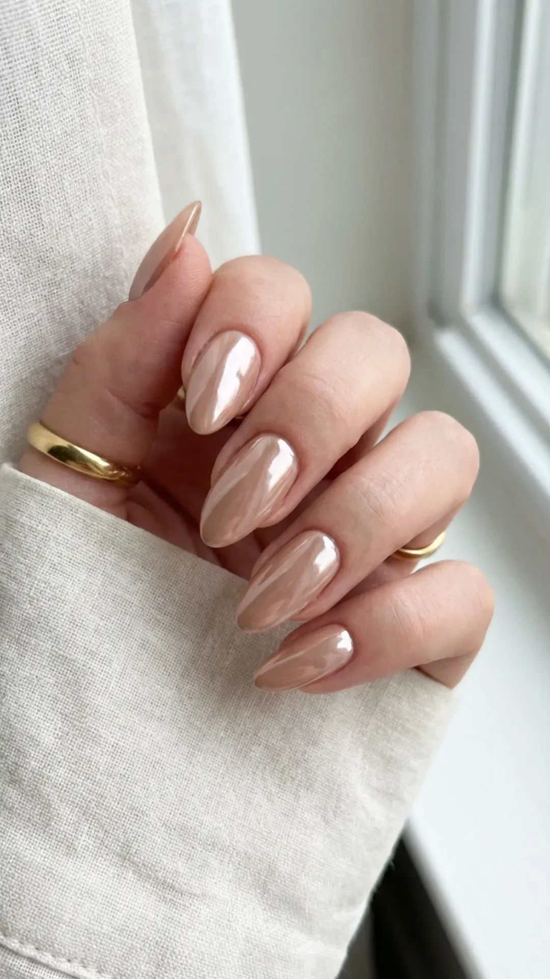 Glossy nude chrome gorgeous nails, almond shape, clean girl aesthetic close-up