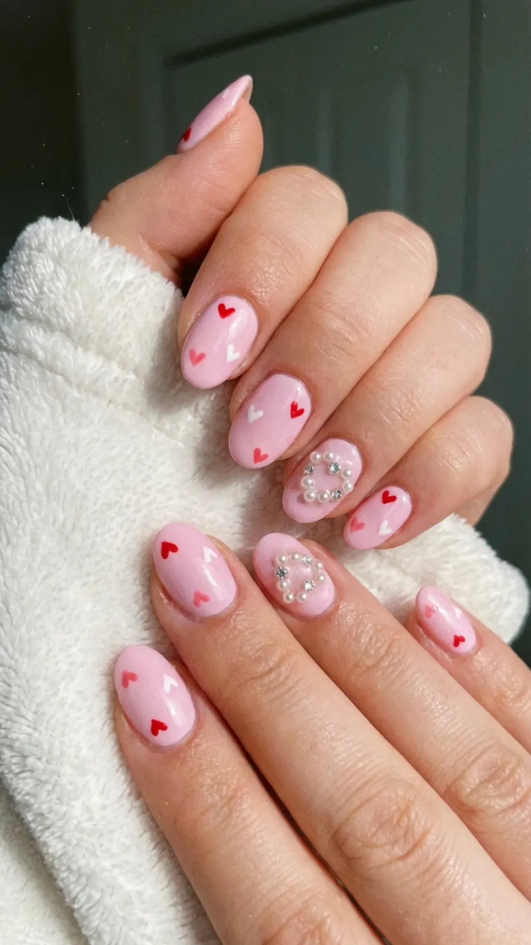 baby pink March nails with tiny heart accents