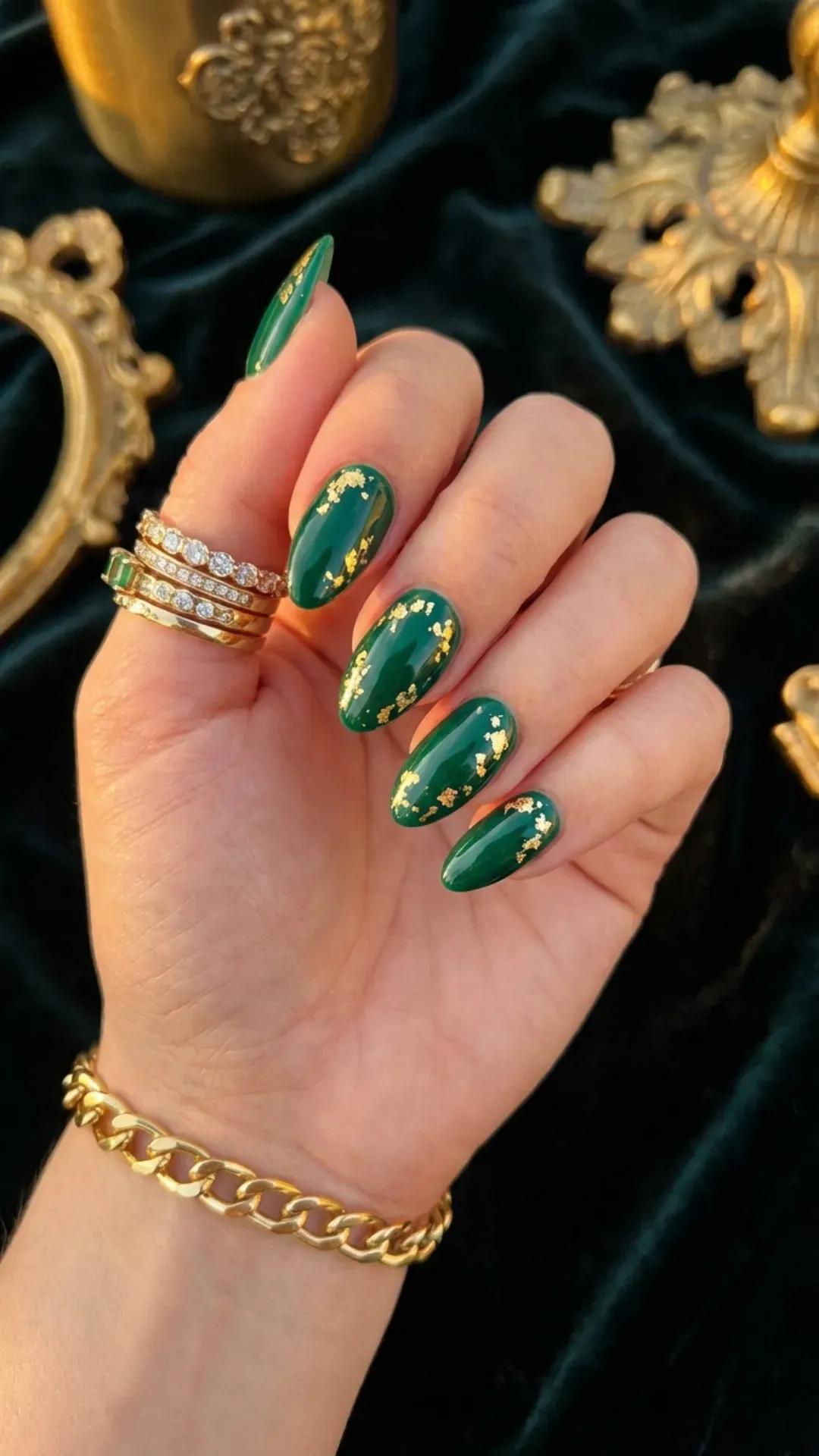 Deep green nails with gold foil flakes luxury manicure