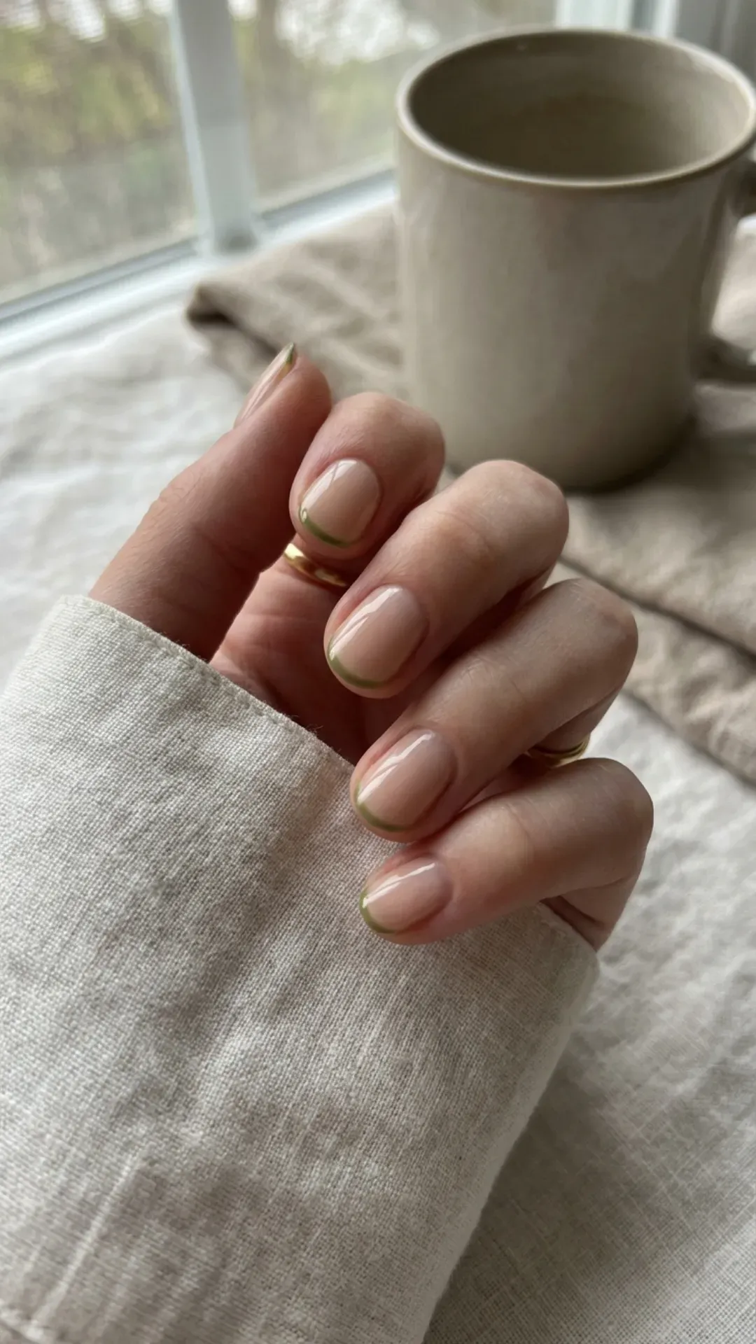 Nude nails with micro green French tips clean girl aesthetic