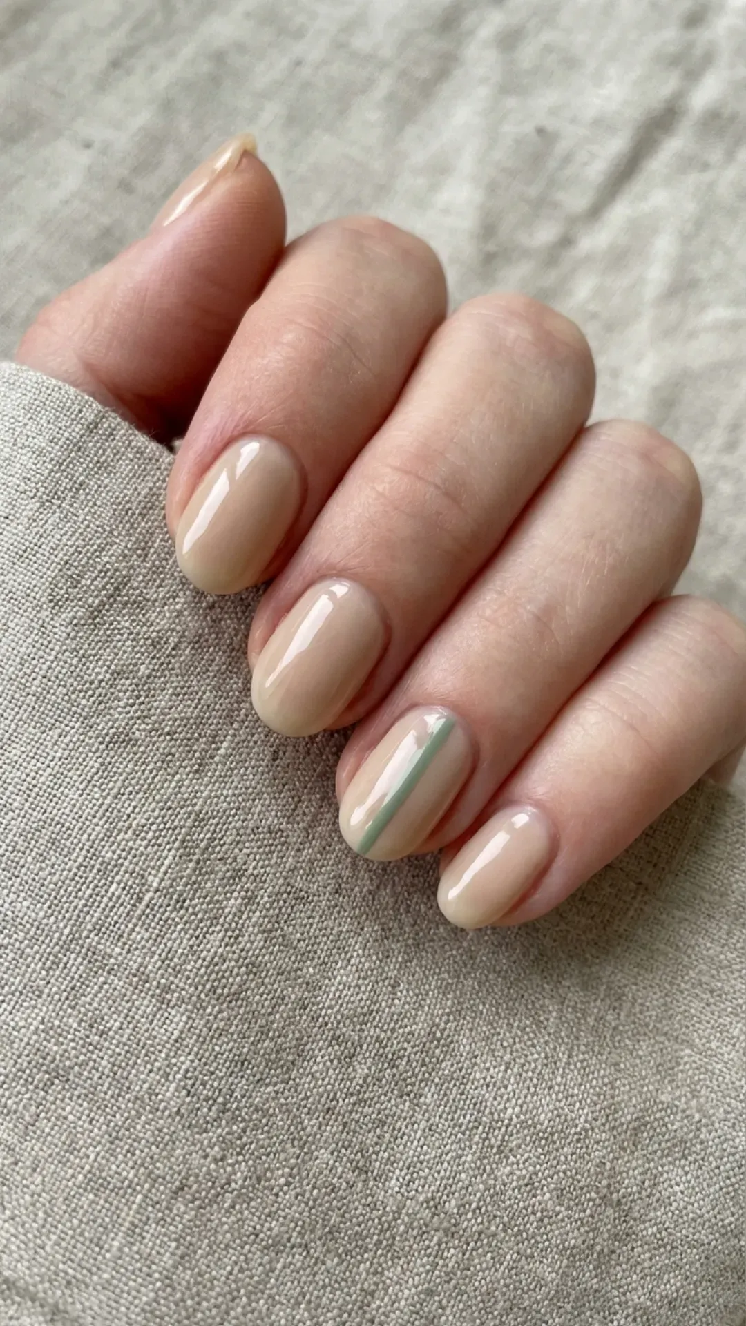 Nude nails with single green line minimalist nail art