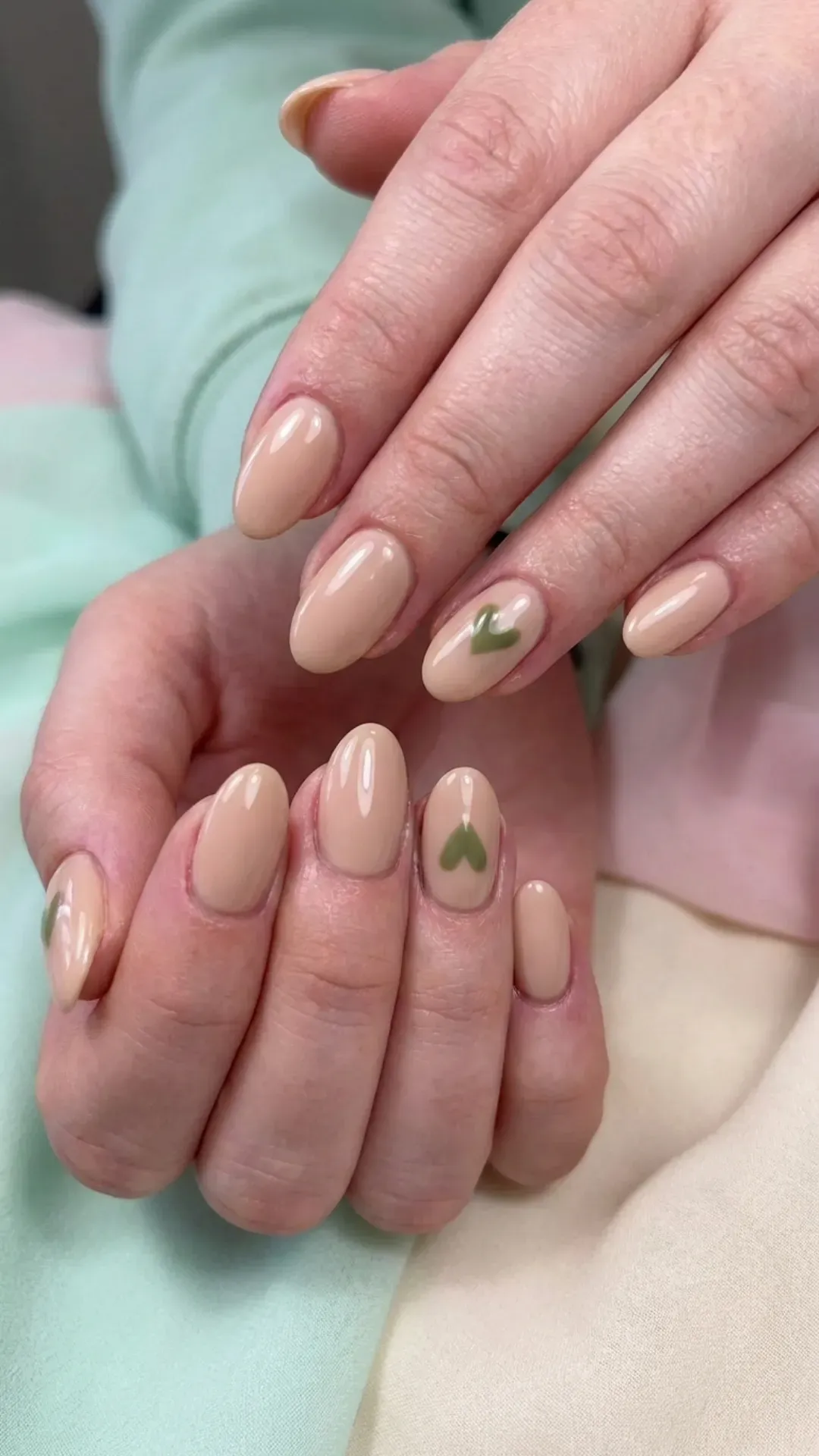 Nude nails with tiny green heart accents cute style
