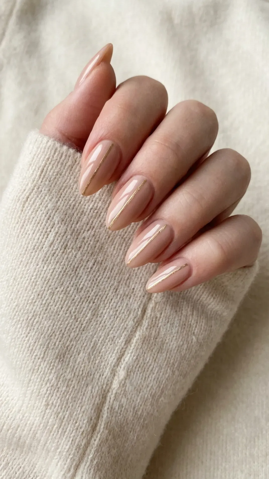 nude March nails with thin gold line detail