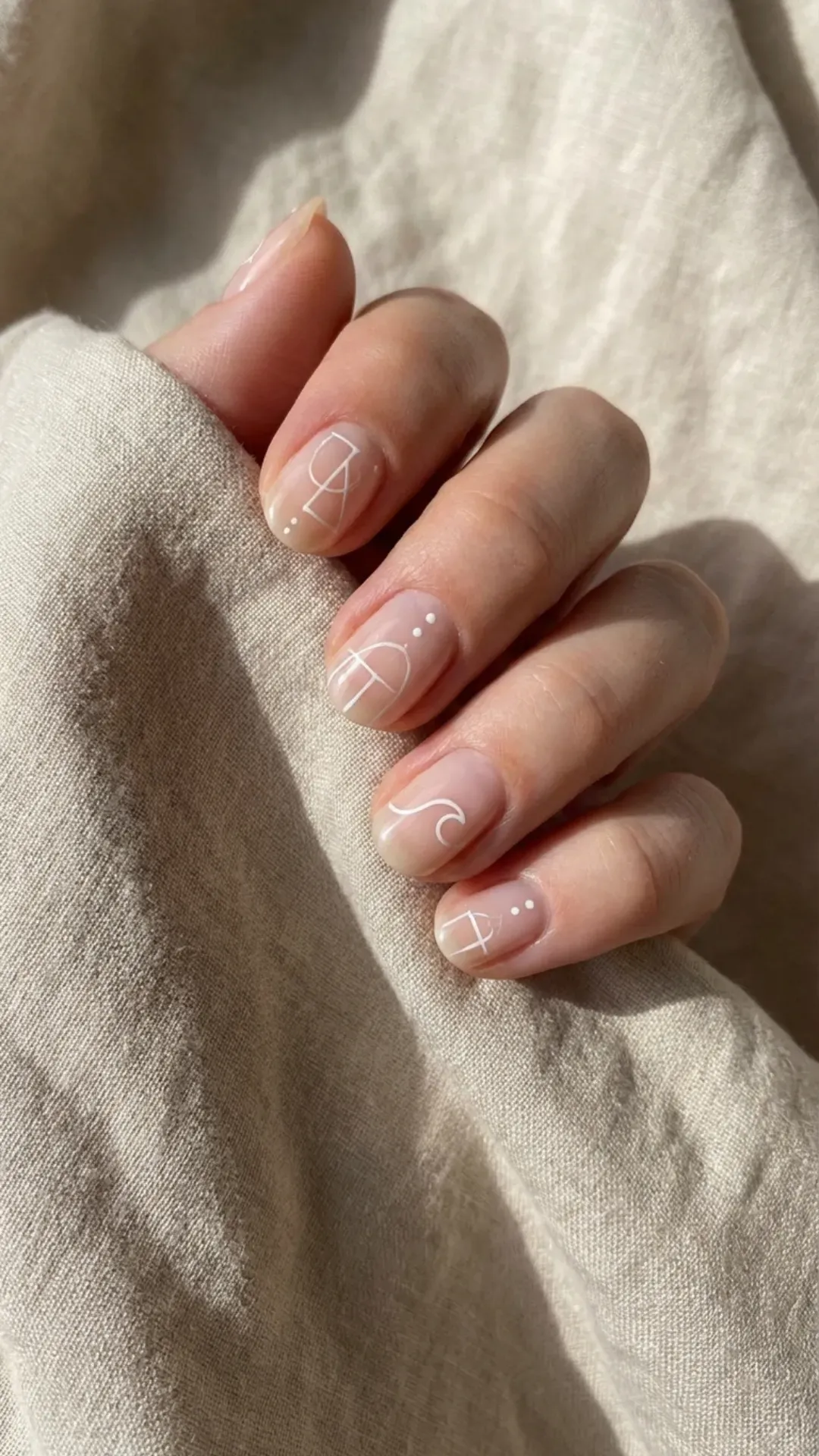 minimalist white line art March nails on neutral base