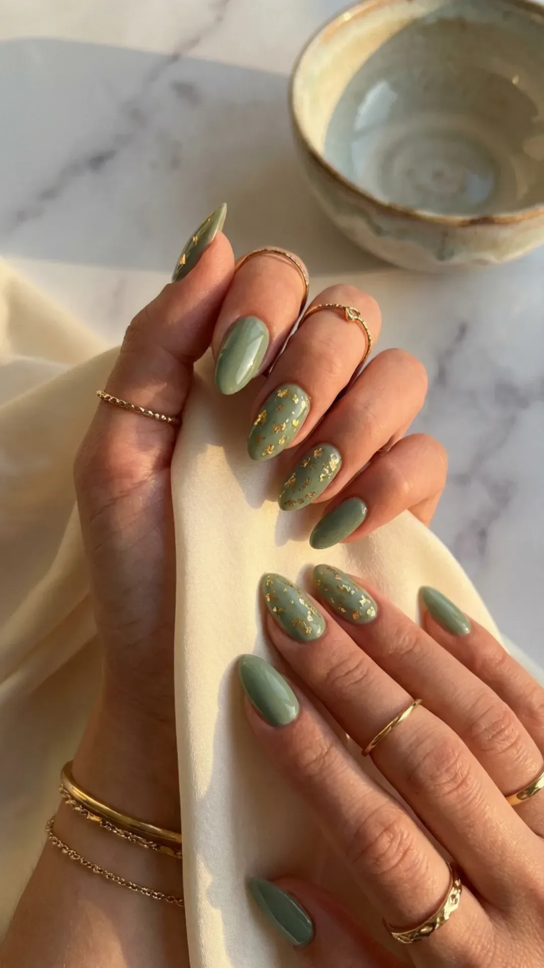 Sage green nails with gold foil accents luxury manicure