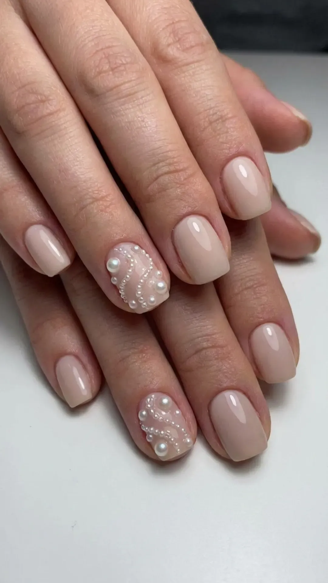 March nails with pearl embellishment accents