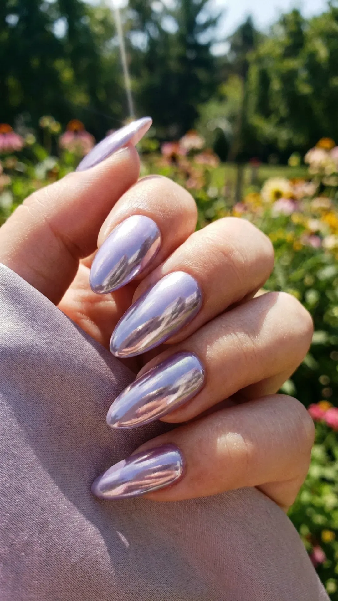 lilac chrome March nails reflecting light on almond shape