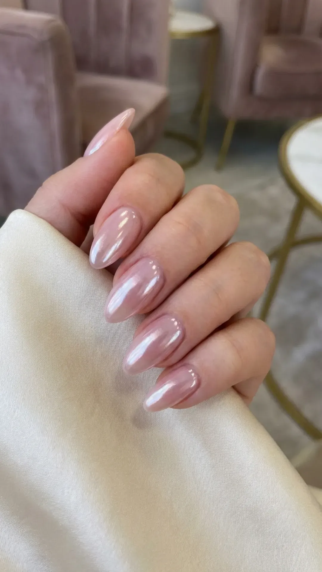 sheer pink almond nails with subtle chrome shine