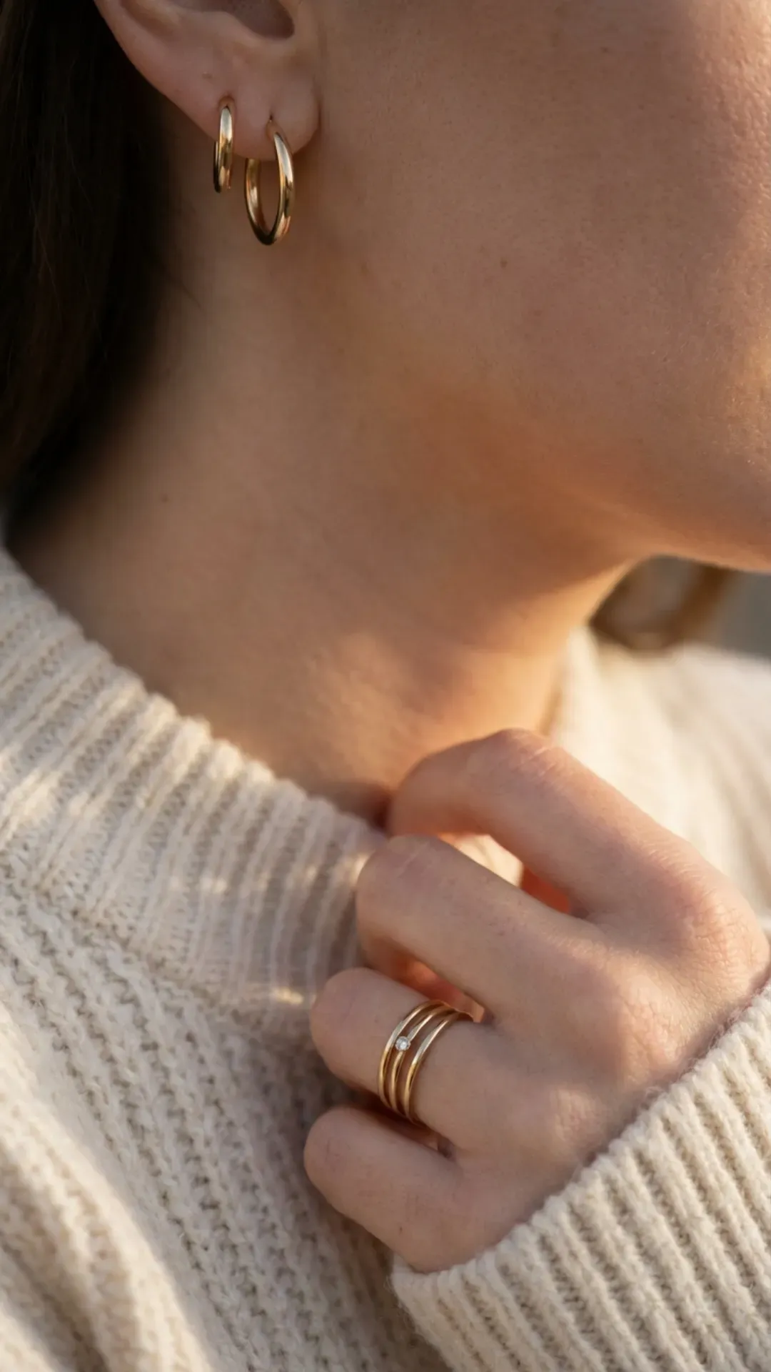Minimal gold hoop earrings and stacked rings styled simply to show how one subtle accessory can elevate an outfit without feeling overdone