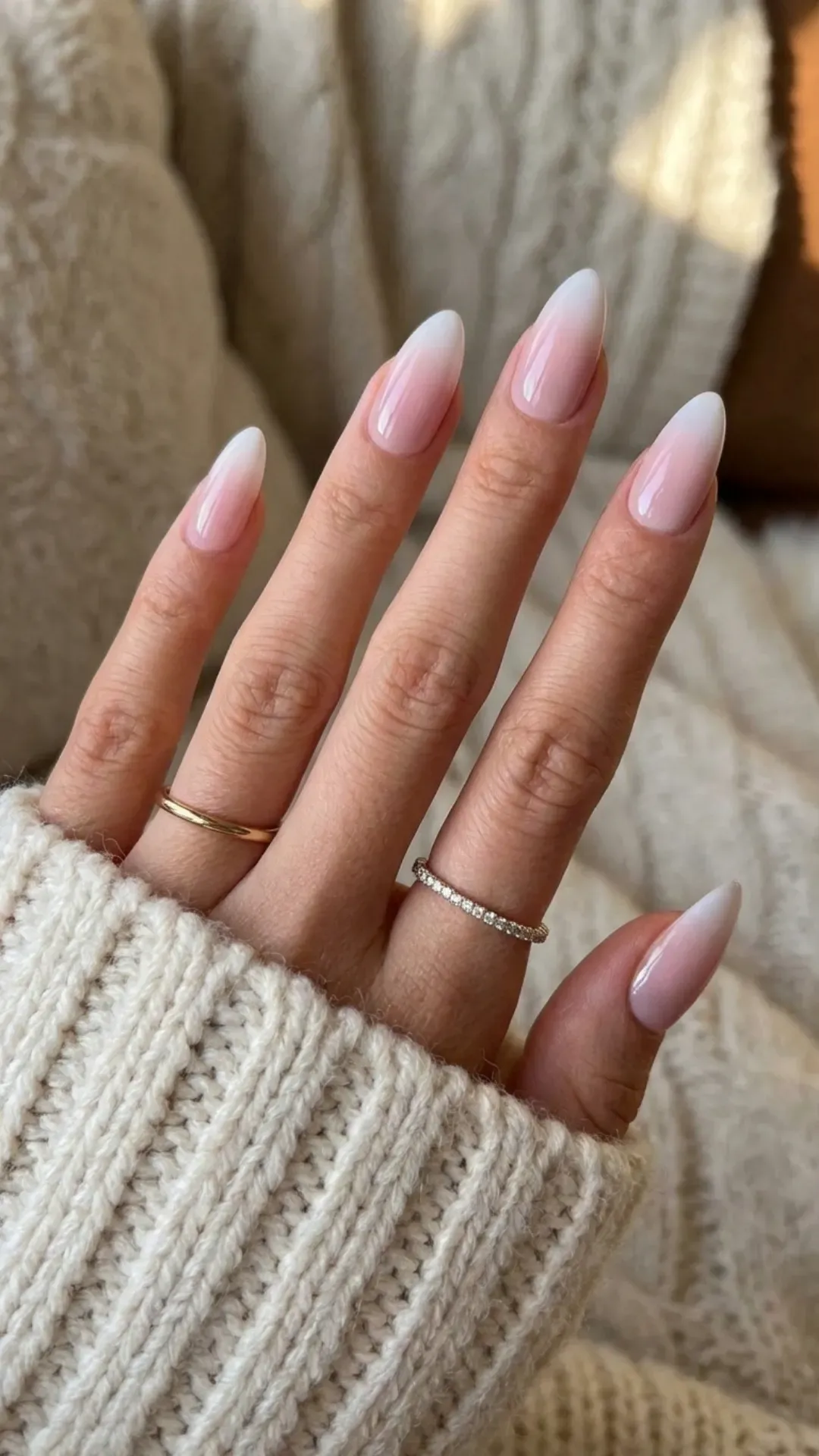 Elegant nude pink ombre almond French tip nails, perfect for adding a touch of sophistication to any look.