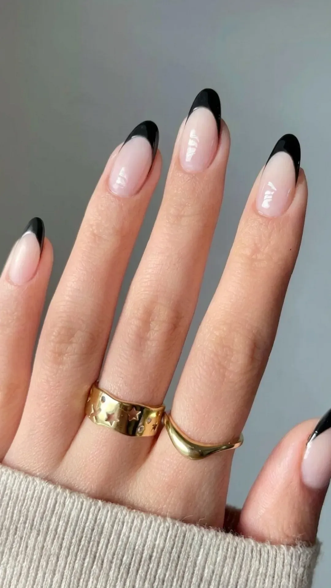 Chic black almond French tip nails featuring a bold contrast for a modern and edgy manicure style.
