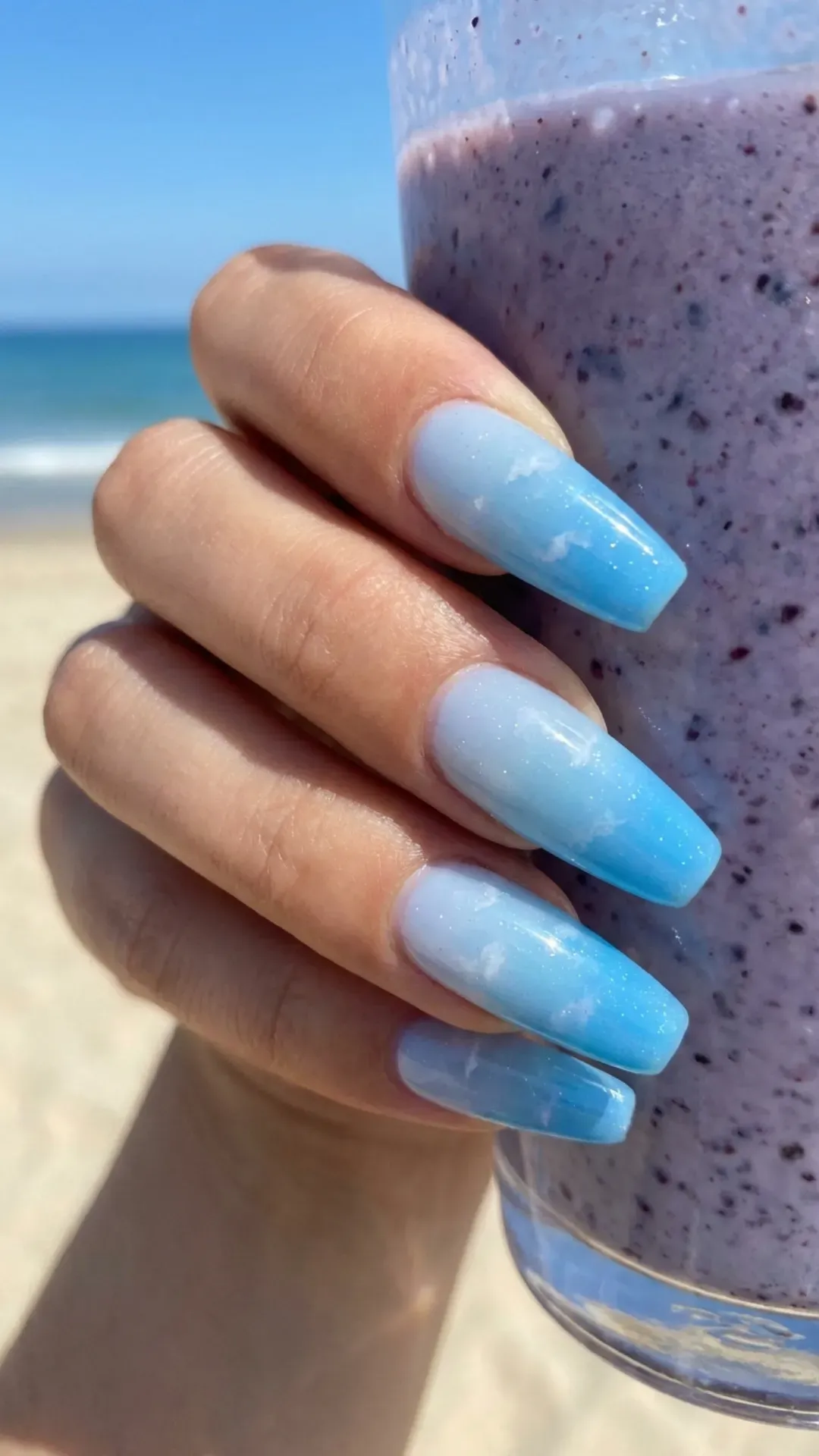 Stylish blueberry milk ombre nails transitioning from a pale to vibrant blue, encapsulating the essence of summer skies