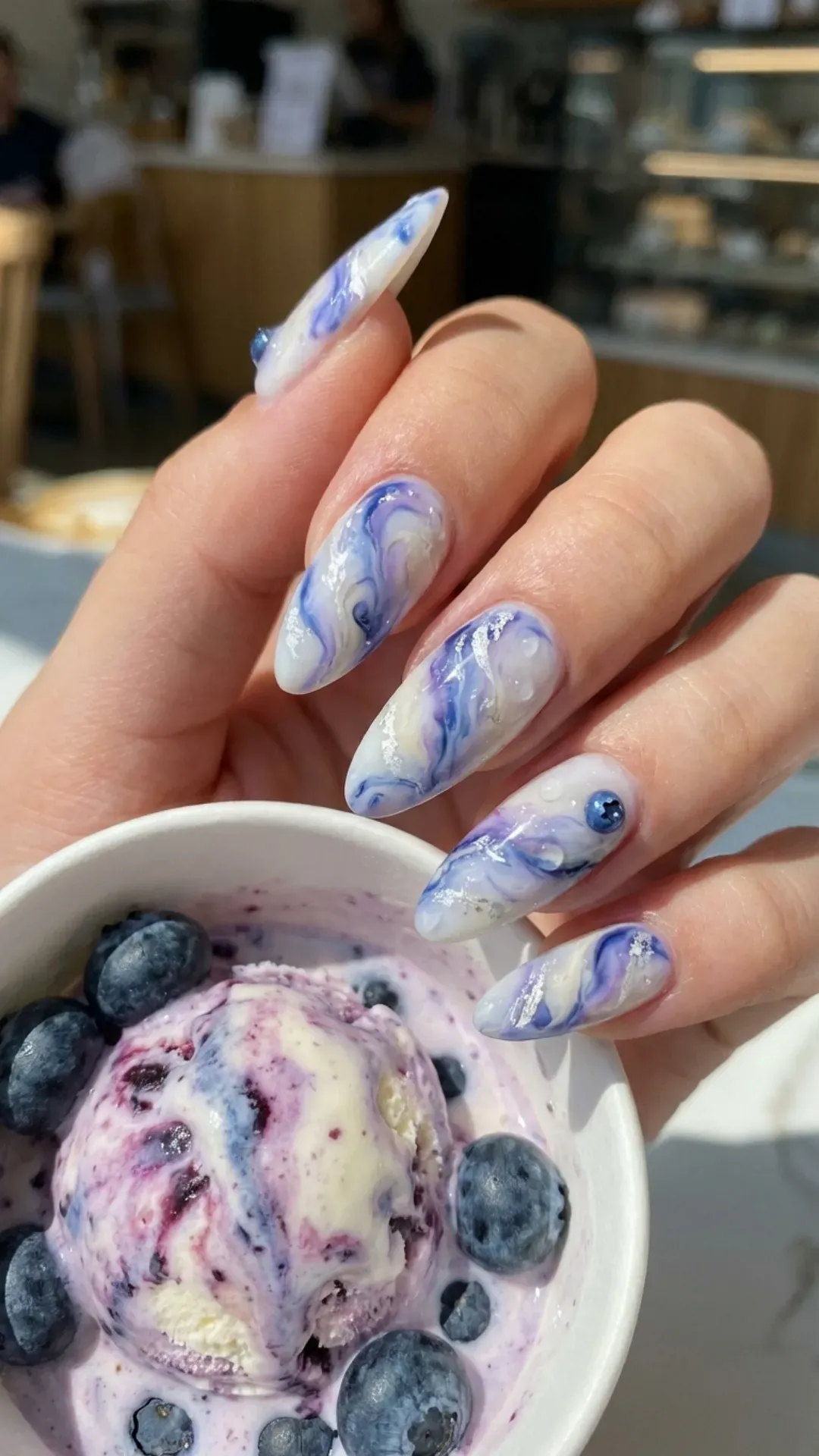 Swirled blueberry milk marble nail design with wisps of white, resembling refreshing blueberry swirl ice cream