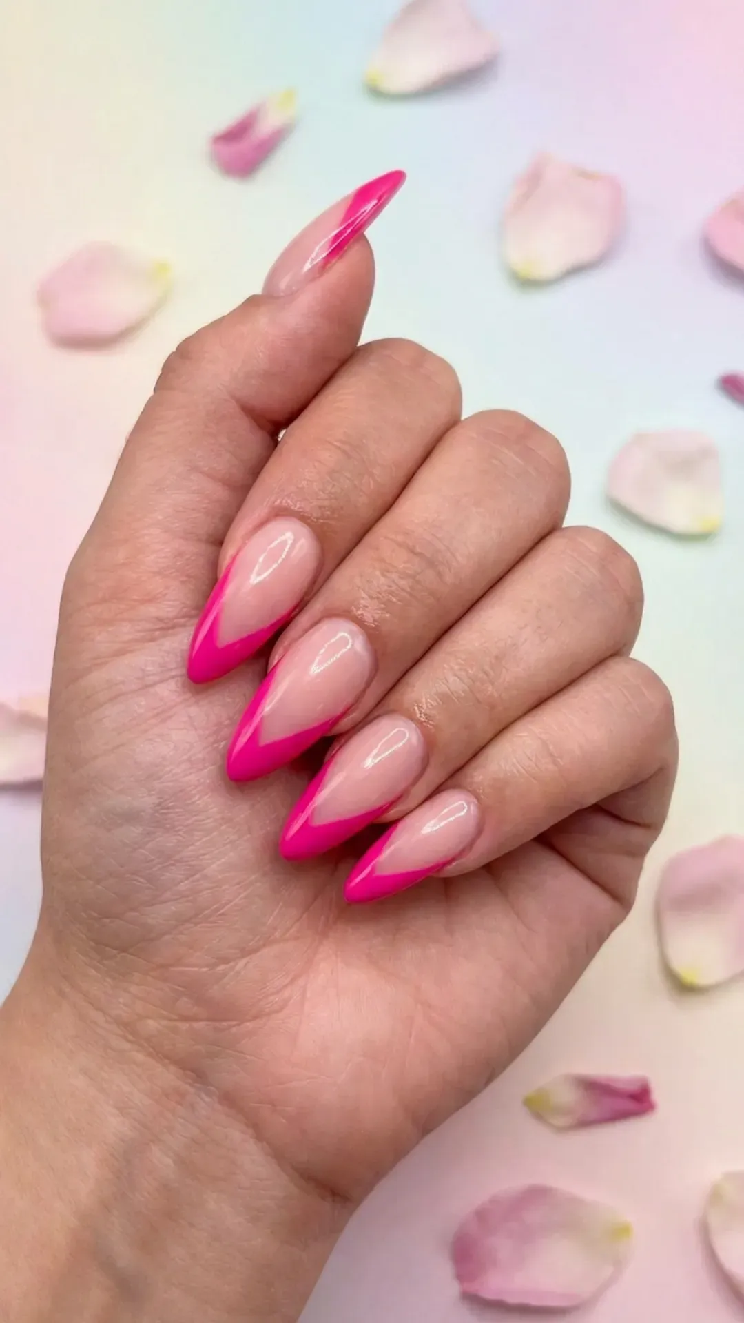 Playful pink V-shaped almond French tip nails, a fun twist on the classic French manicure for a flirty vibe.