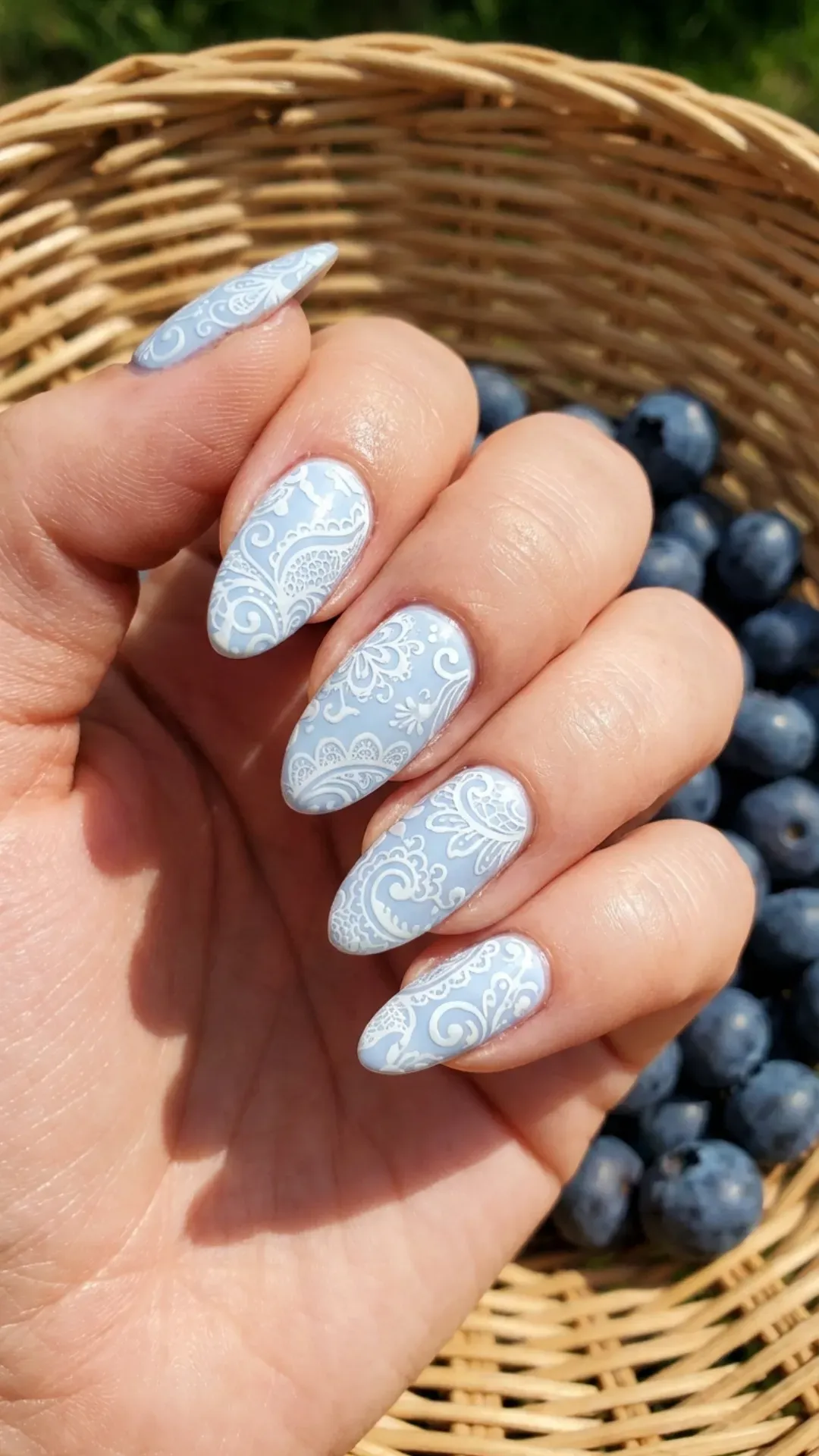 Intricate blueberry milk stamping nails with detailed white patterns, offering an artistic flair to a classic summer look