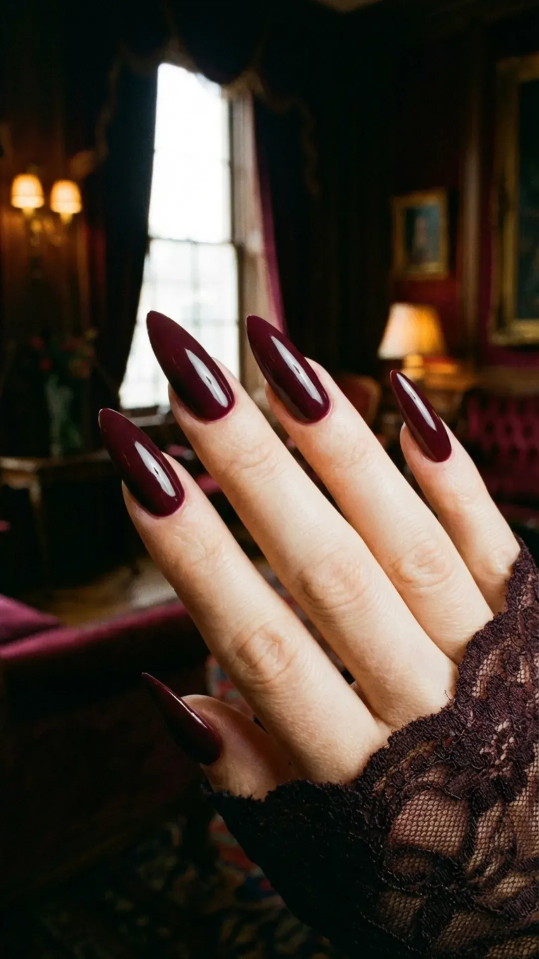 Deep burgundy glossy stiletto nails in a rich wine shade