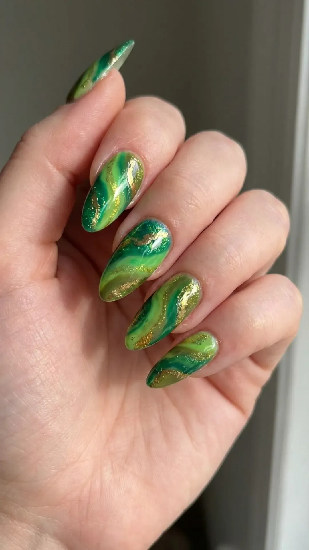 Funky green nails with gold highlights and abstract art patterns