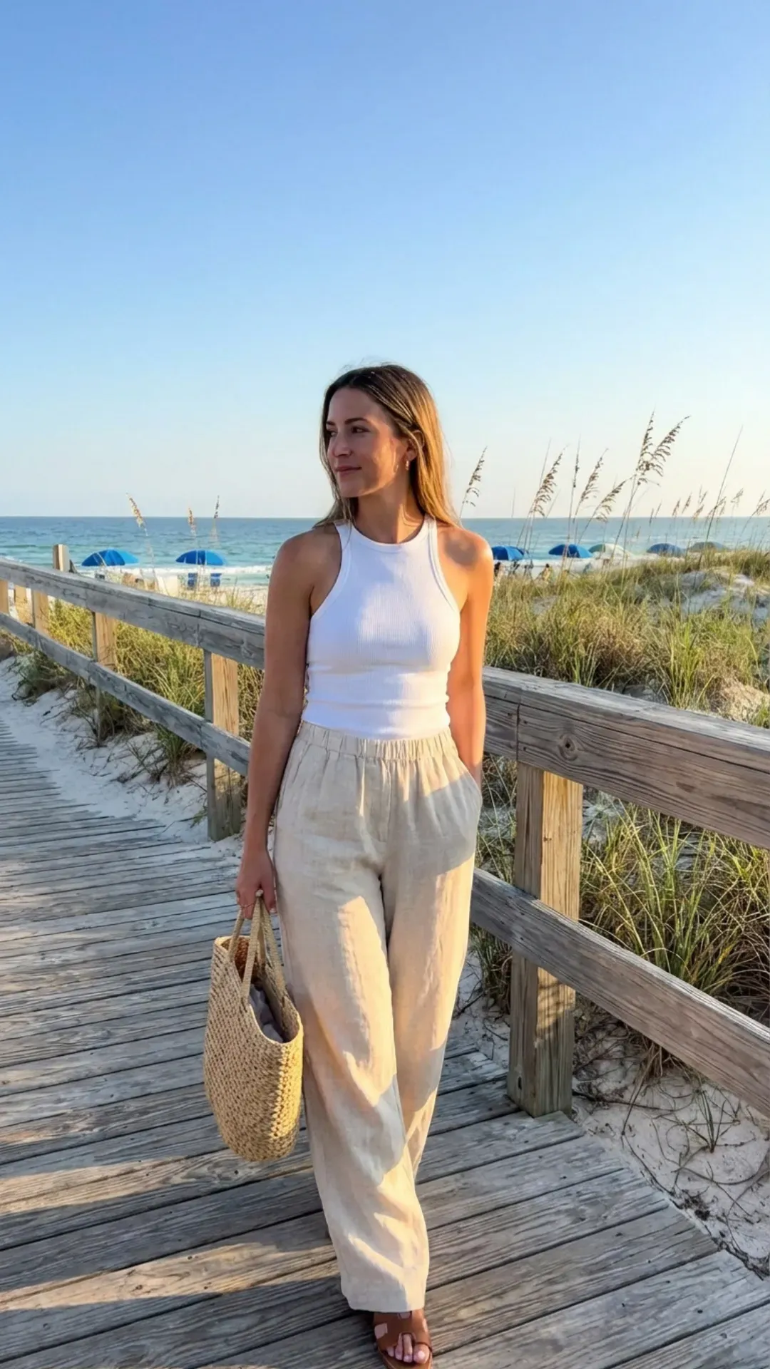 Beige linen pants and a white tank top for a simple summer casual outfit