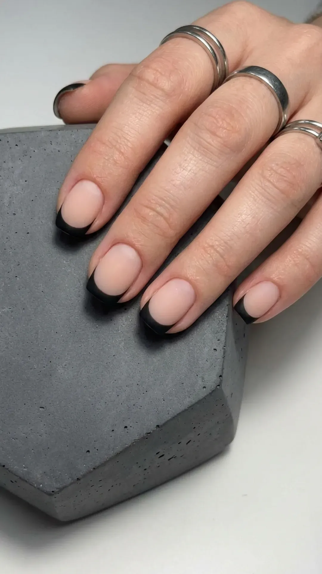 A modern take on the French manicure, these short nails boast matte black tips for a sleek and stylish monochromatic design.