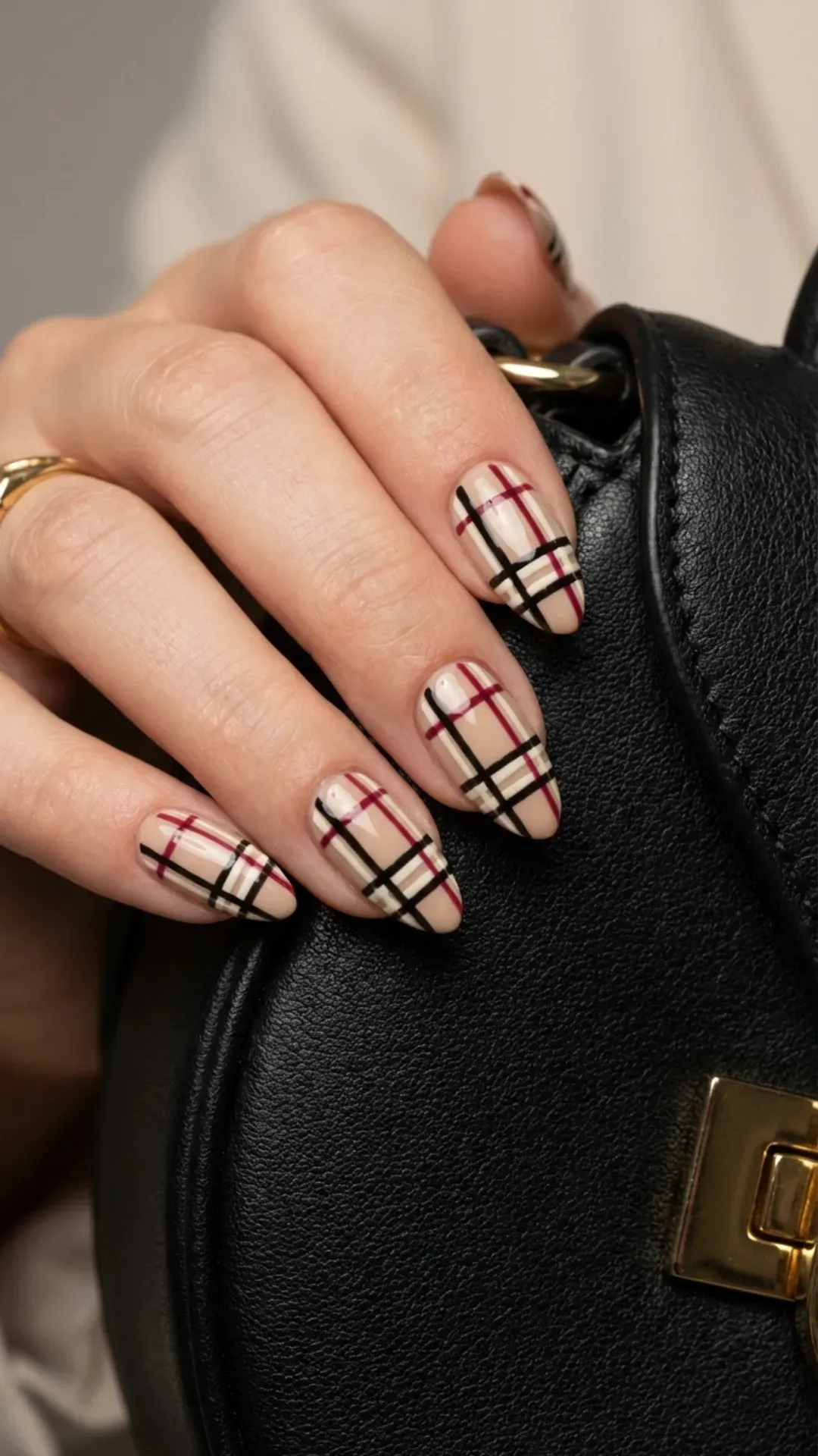 Bold red stiletto nails, some featuring glossy finish and others adorned with gold embellishments for a luxurious statement.