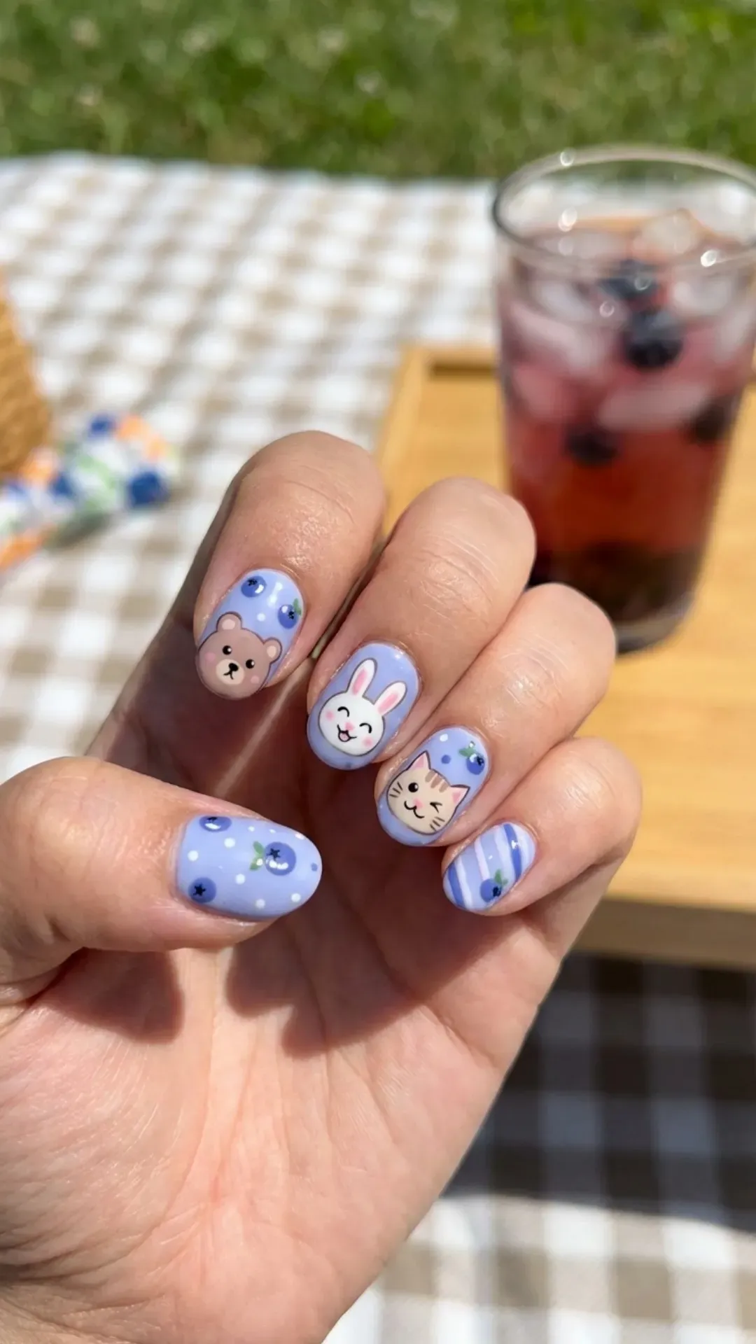 Adorable blueberry milk cartoon nails featuring cute animal faces and patterns, perfect for playful summer days