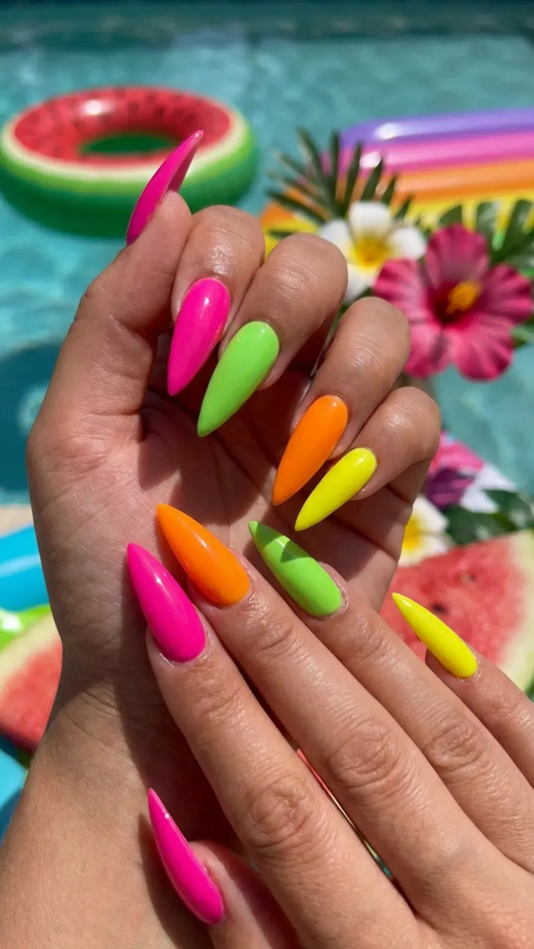 Neon stiletto nails in bright summer shades with glossy shine