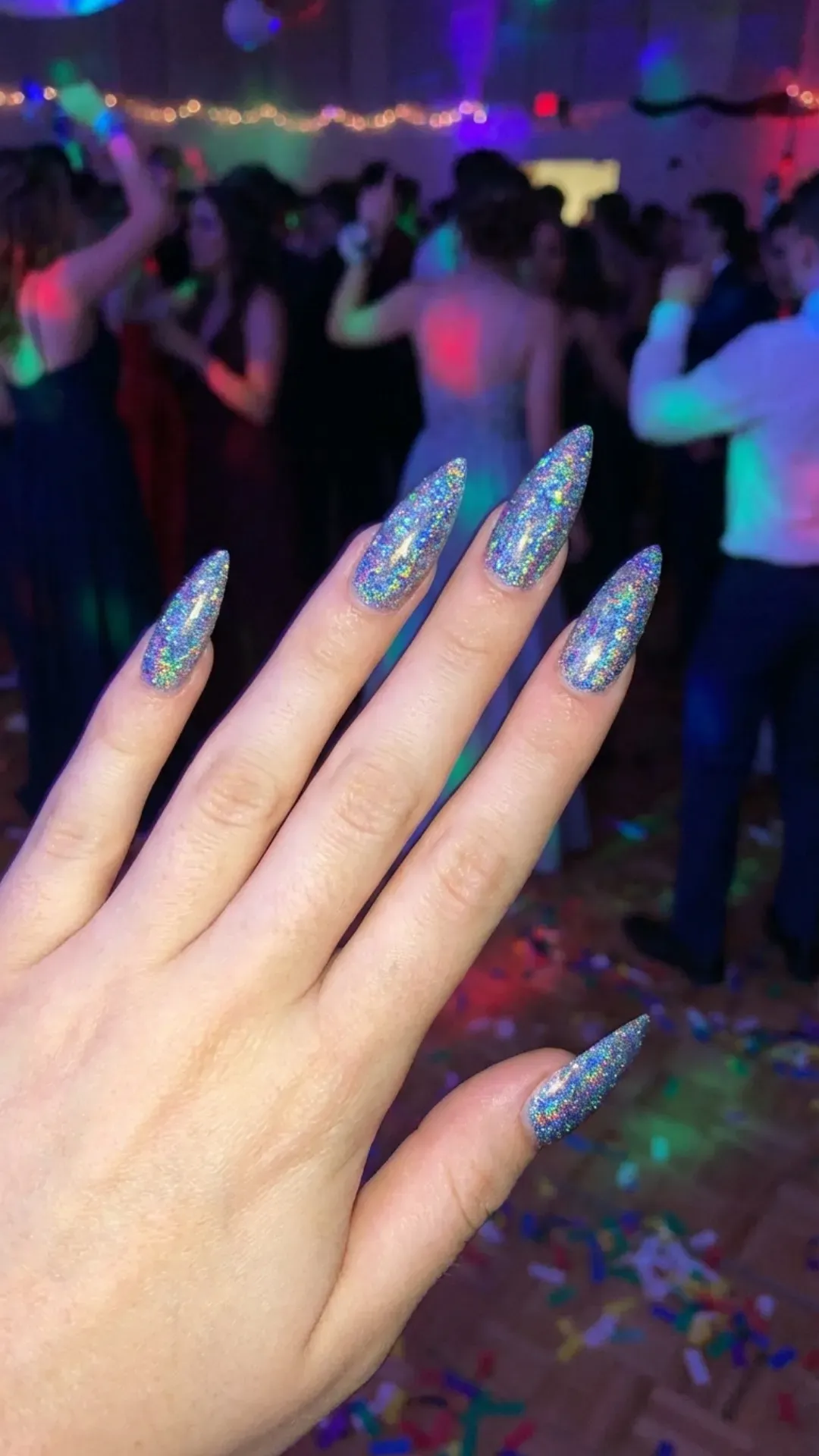 Holographic glitter prom nails reflecting rainbow colors, party manicure