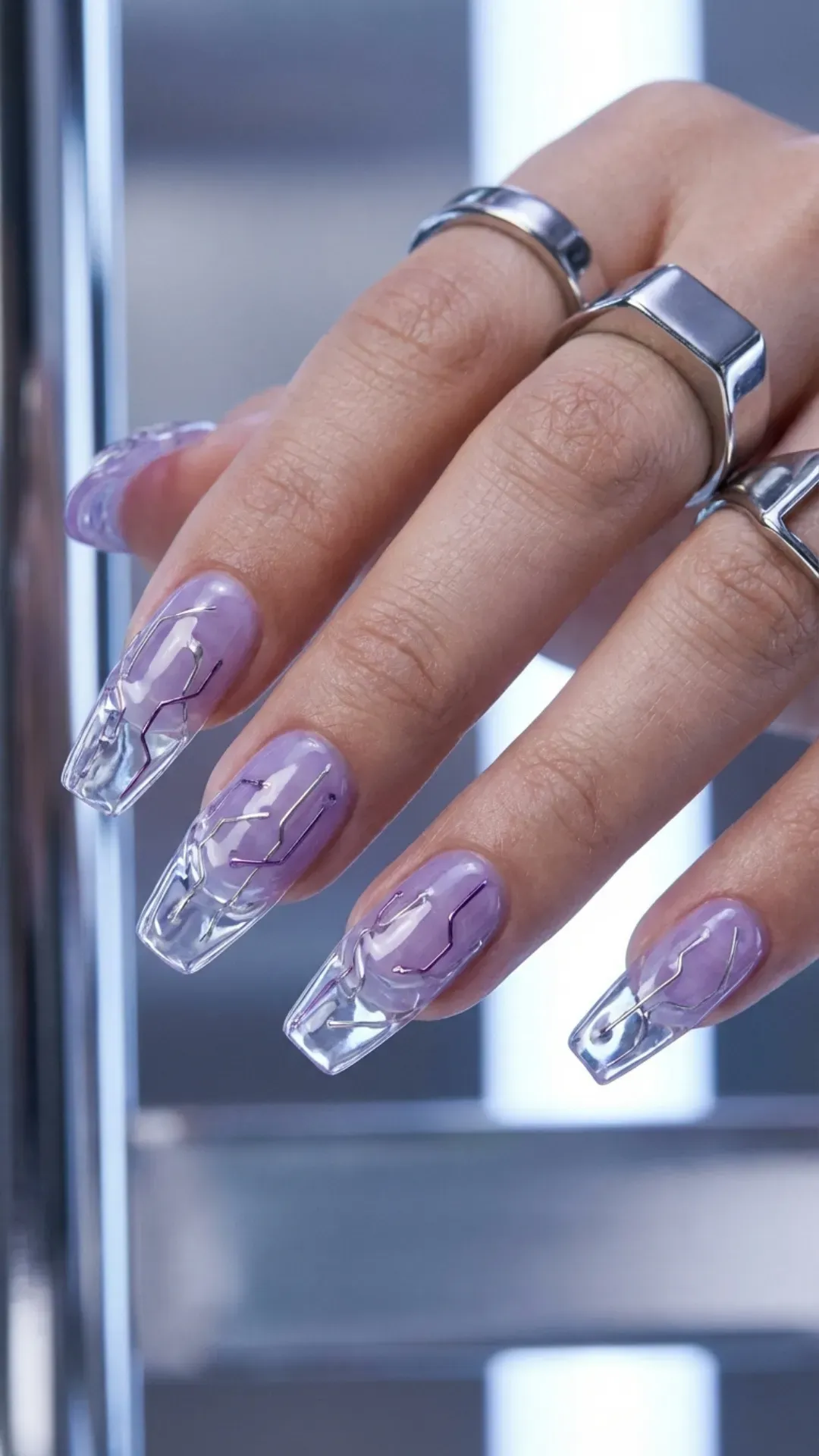 Clear gel nails encapsulating silver wire over a digital lavender base VANSWEG.COM