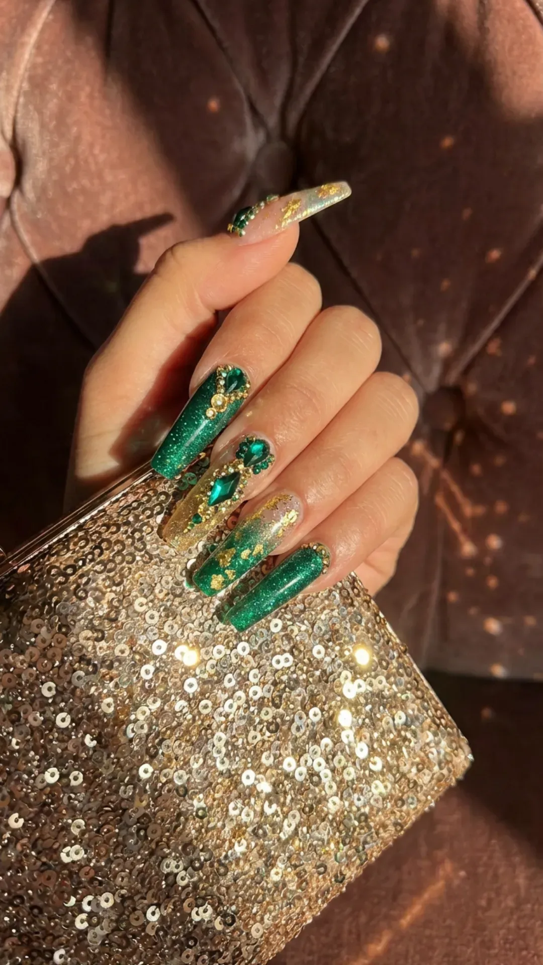 Emerald green long nails with gold rhinestones and glitter details